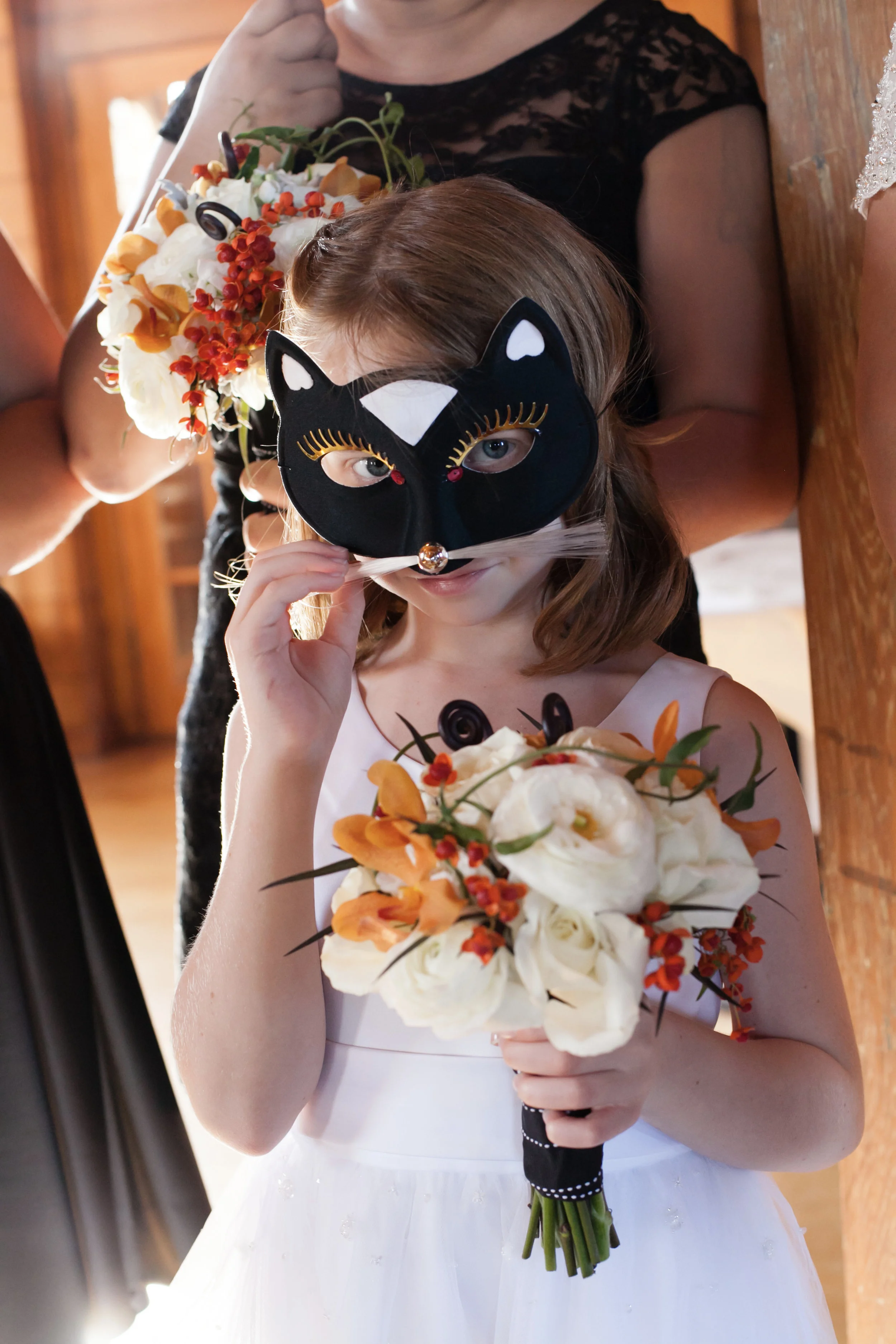 Flower girl with a mask at a Halloween wedding