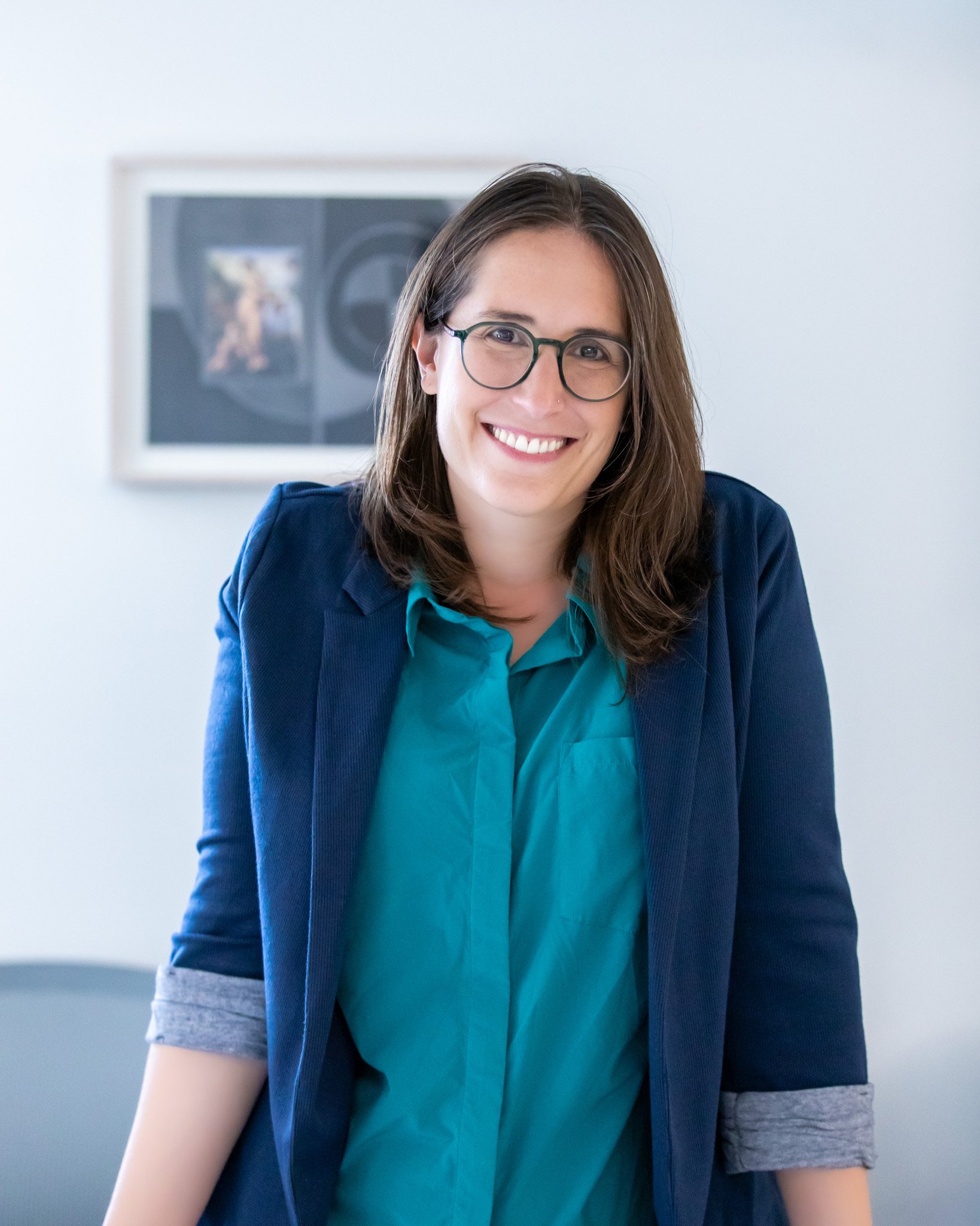  professional nyc headshot of a female standing at her desk by Elizabeth Solaka Photography 