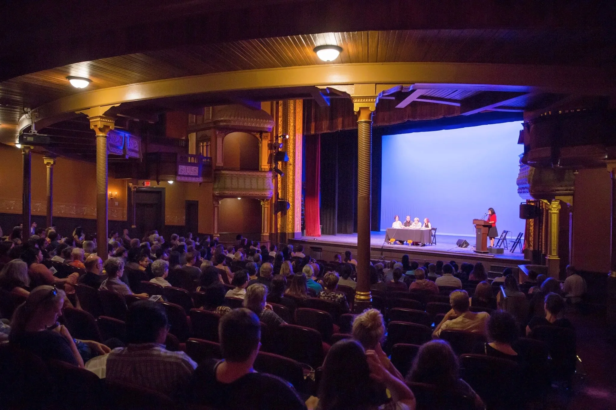  A theatre filled with people at an NYC University panel discussion taken by Elizabeth Solaka, New York Corporate event photographer 