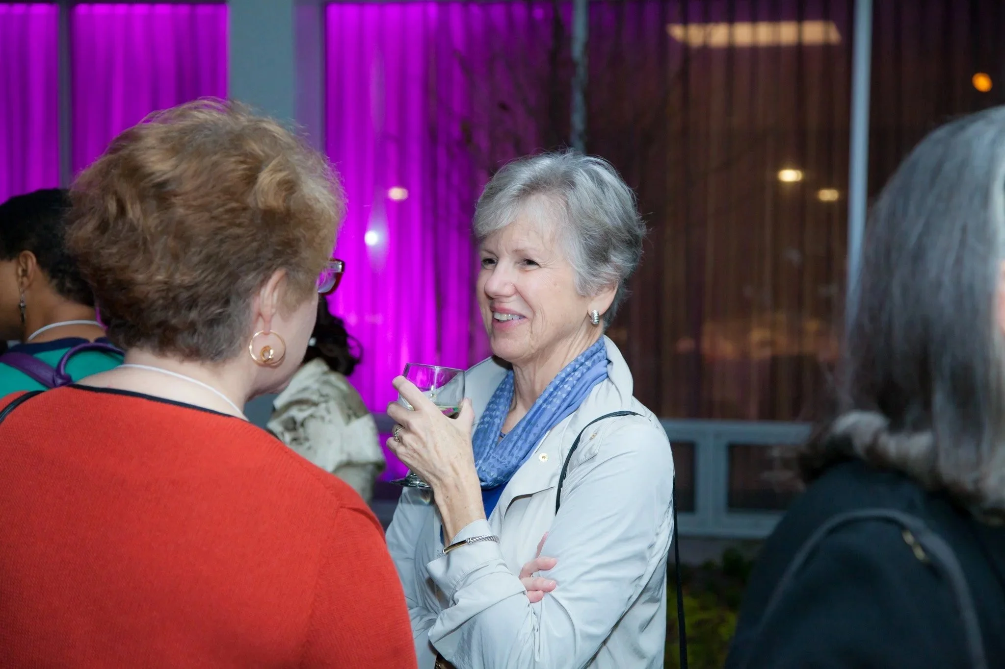  Woman smiles and holds a glass at a corporate event nyc taken by Elizabeth Solaka 