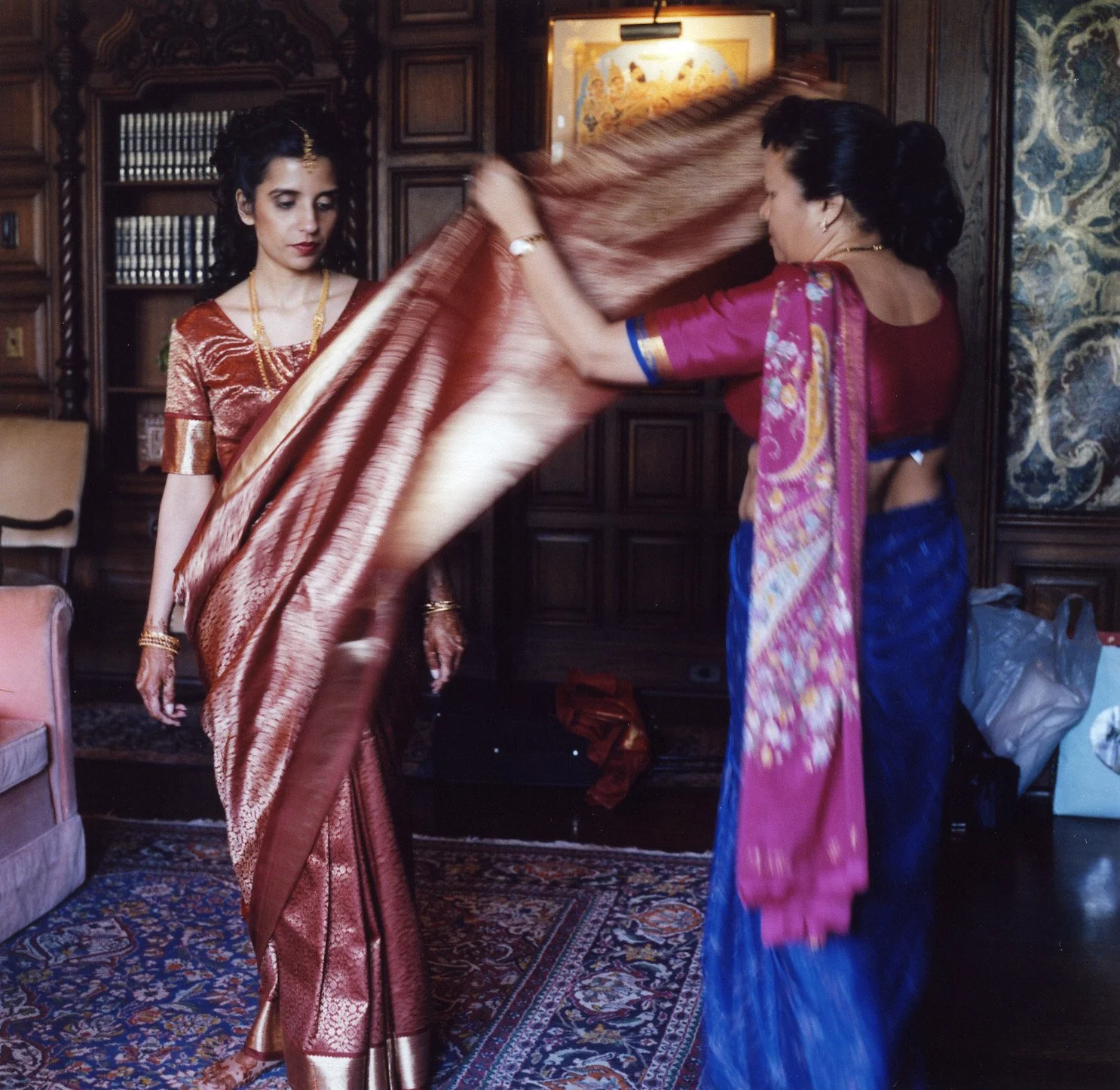  New York Indian wedding preparations Indian Bride and mom shows bride how to put on a sari 