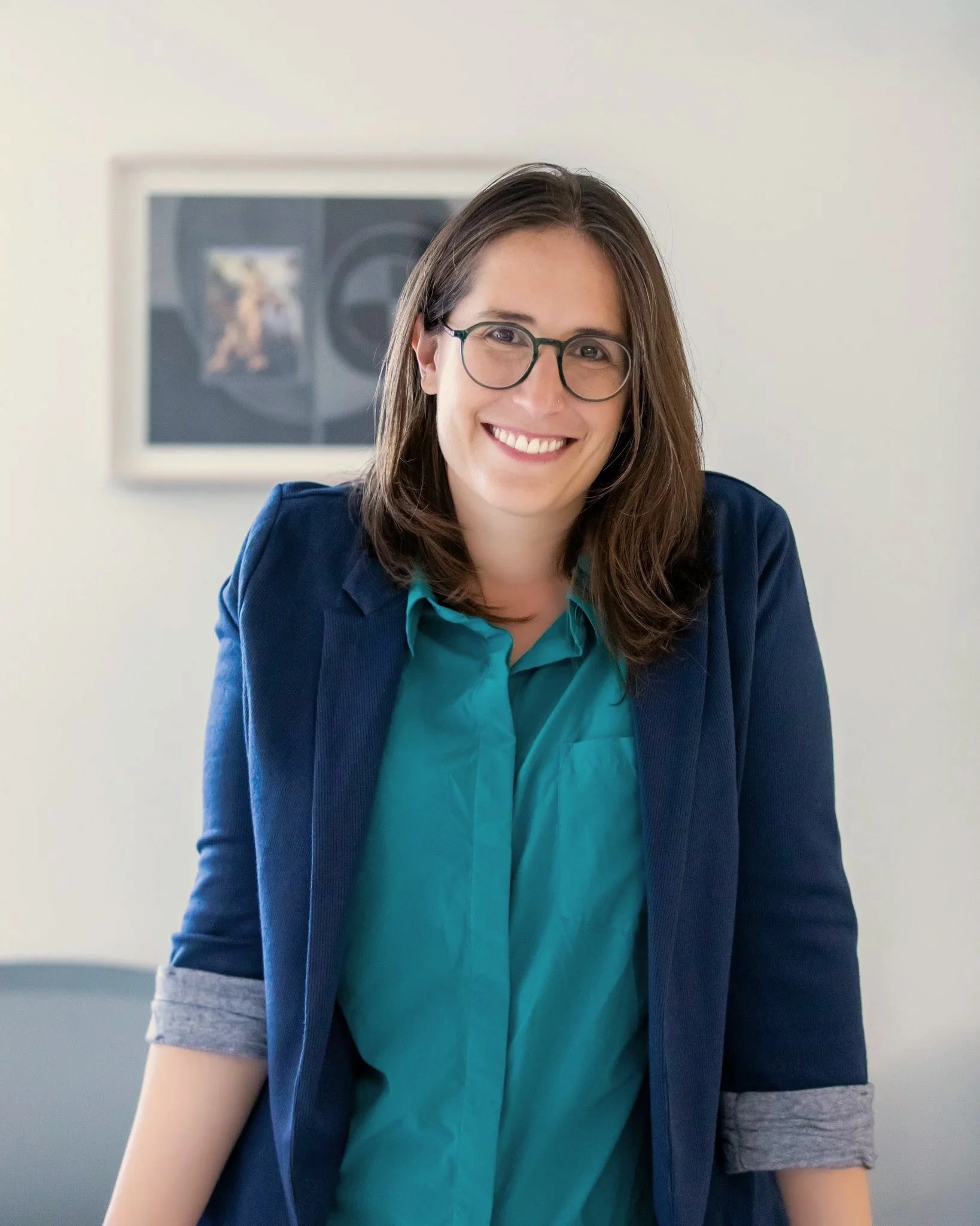  professional nyc headshot of a female standing at her desk by Elizabeth Solaka Photography 