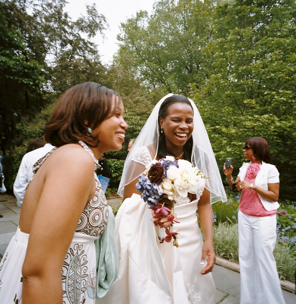 bride laughing with her bridesmaid in outdoor Central Park wedding