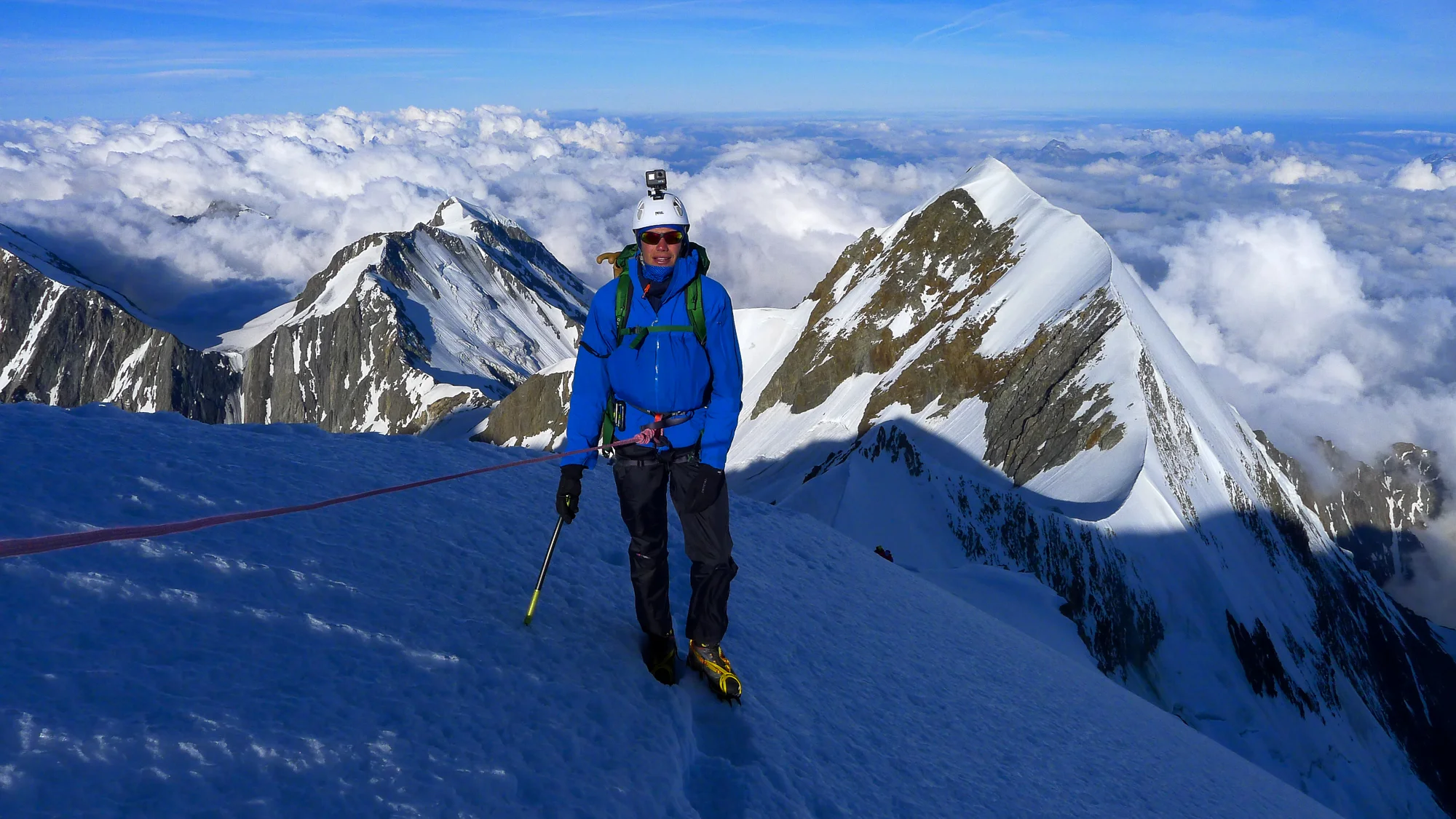 Dave on the Pope Route. The Aiguille du Bionnassay traverse climbs the very narrow crest in the background.