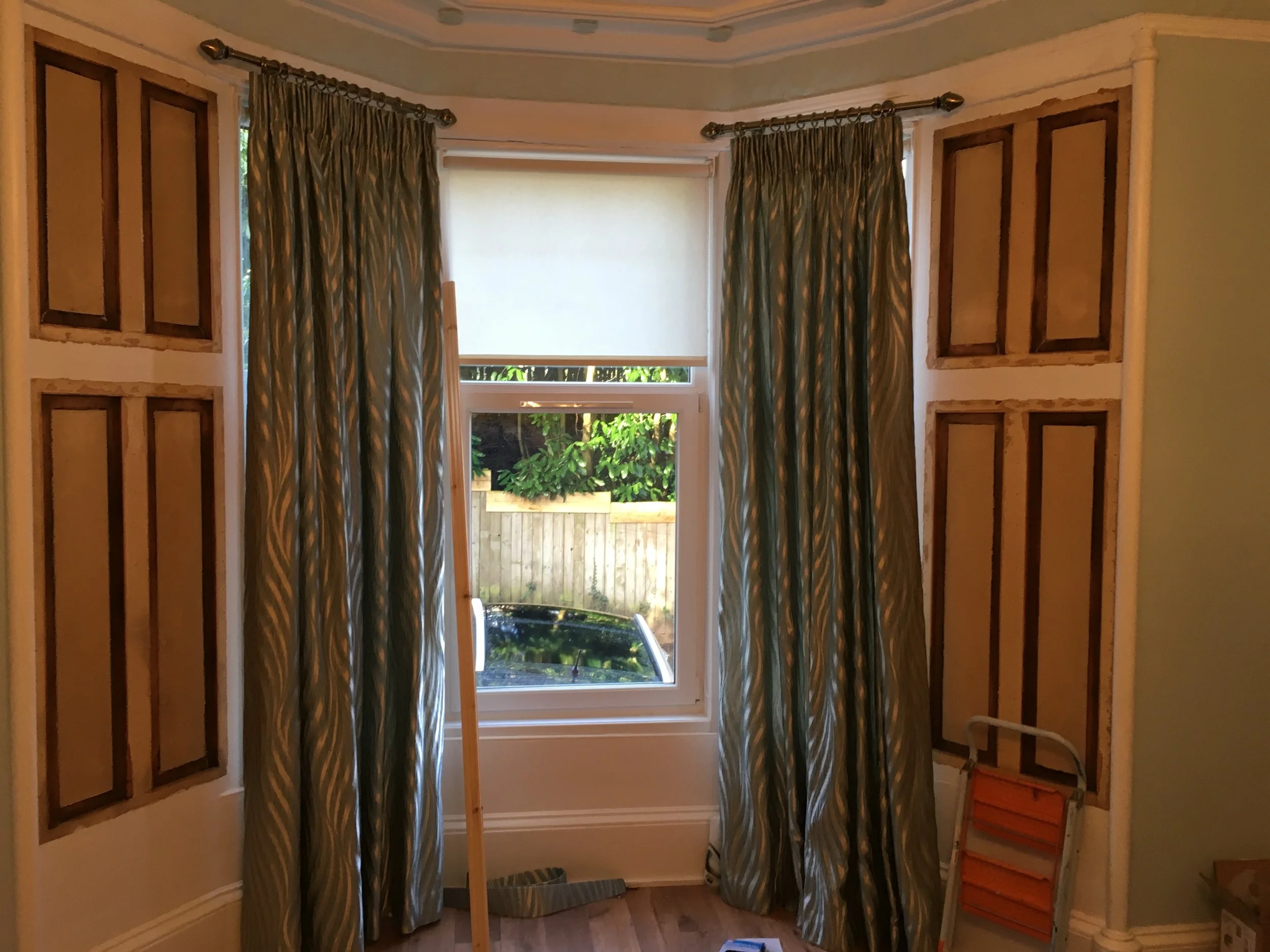  Hardboard removed to expose original decorative window panels. 