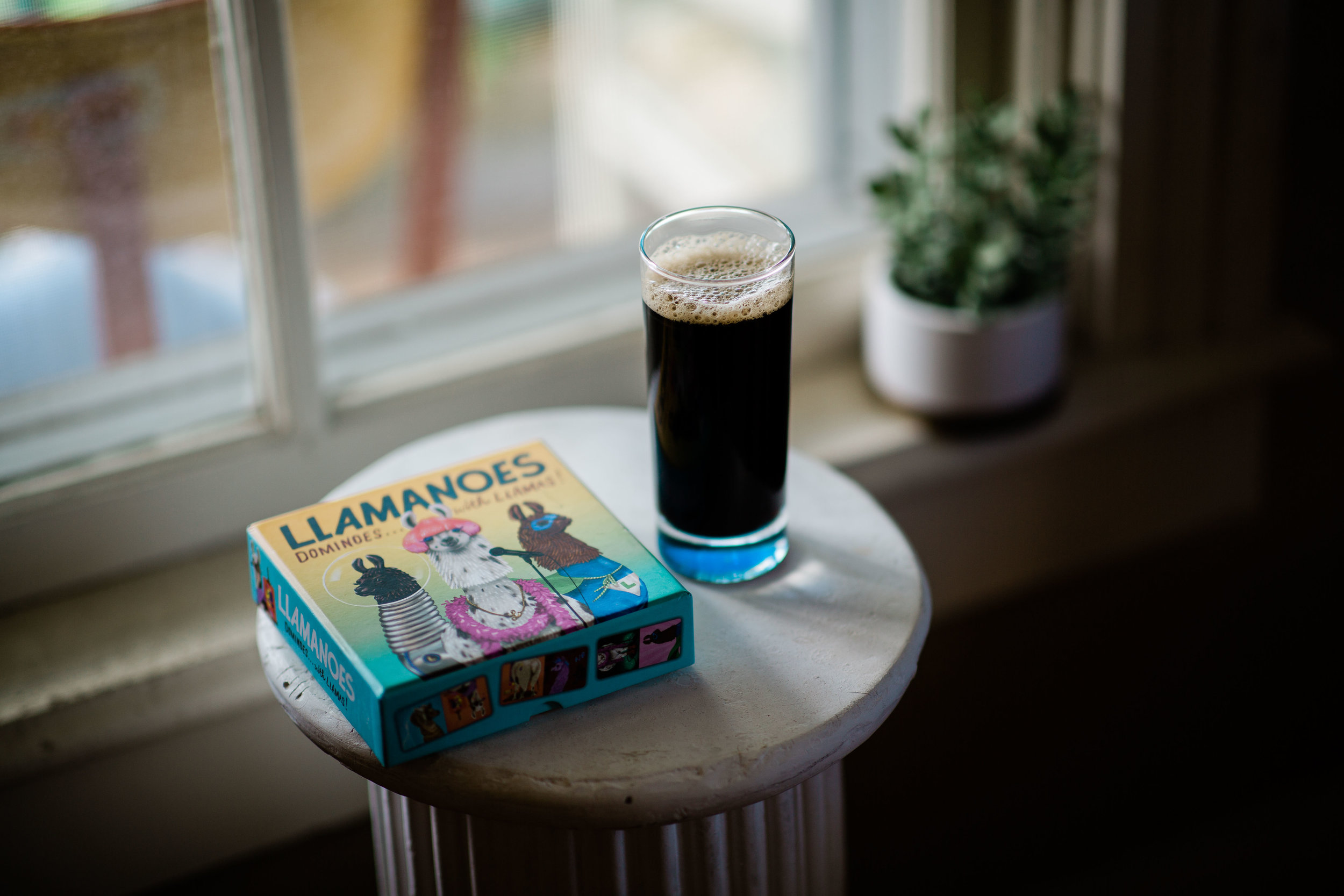 coffee in tall glass with llama dominoes on podium