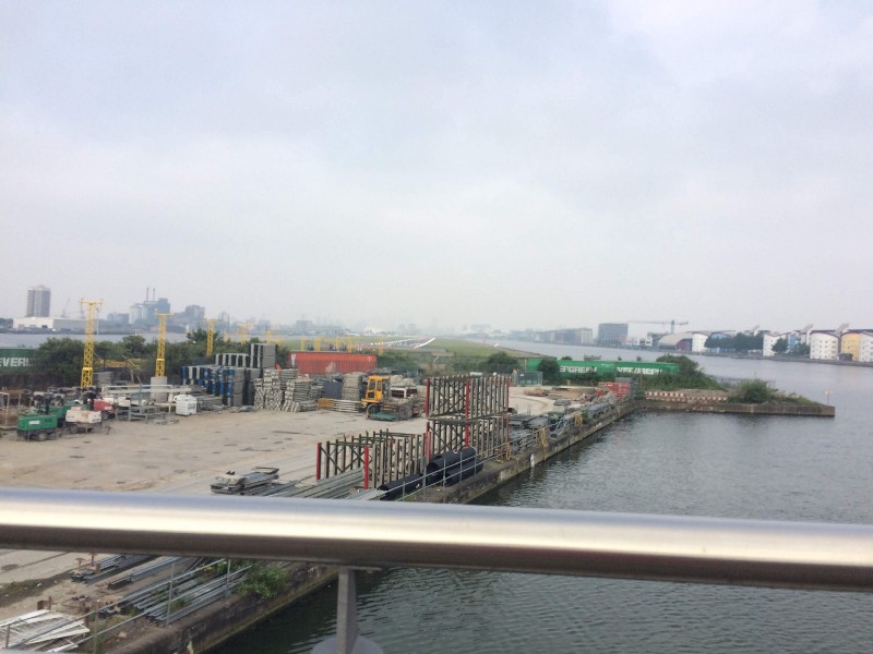 Runway view from the bridge, towards which the approach light towers loom.