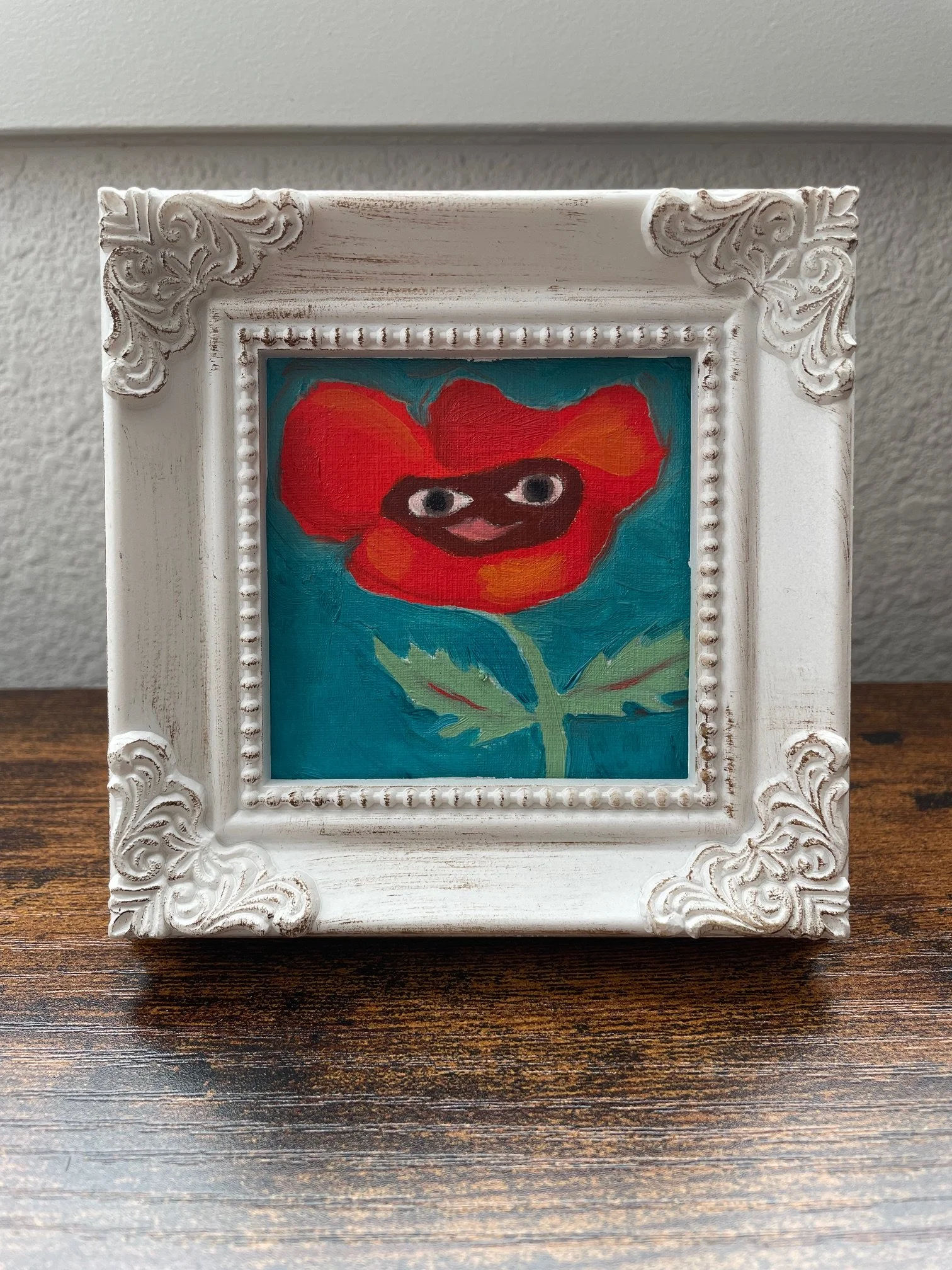 Oil painting of a smiling red poppy flower
