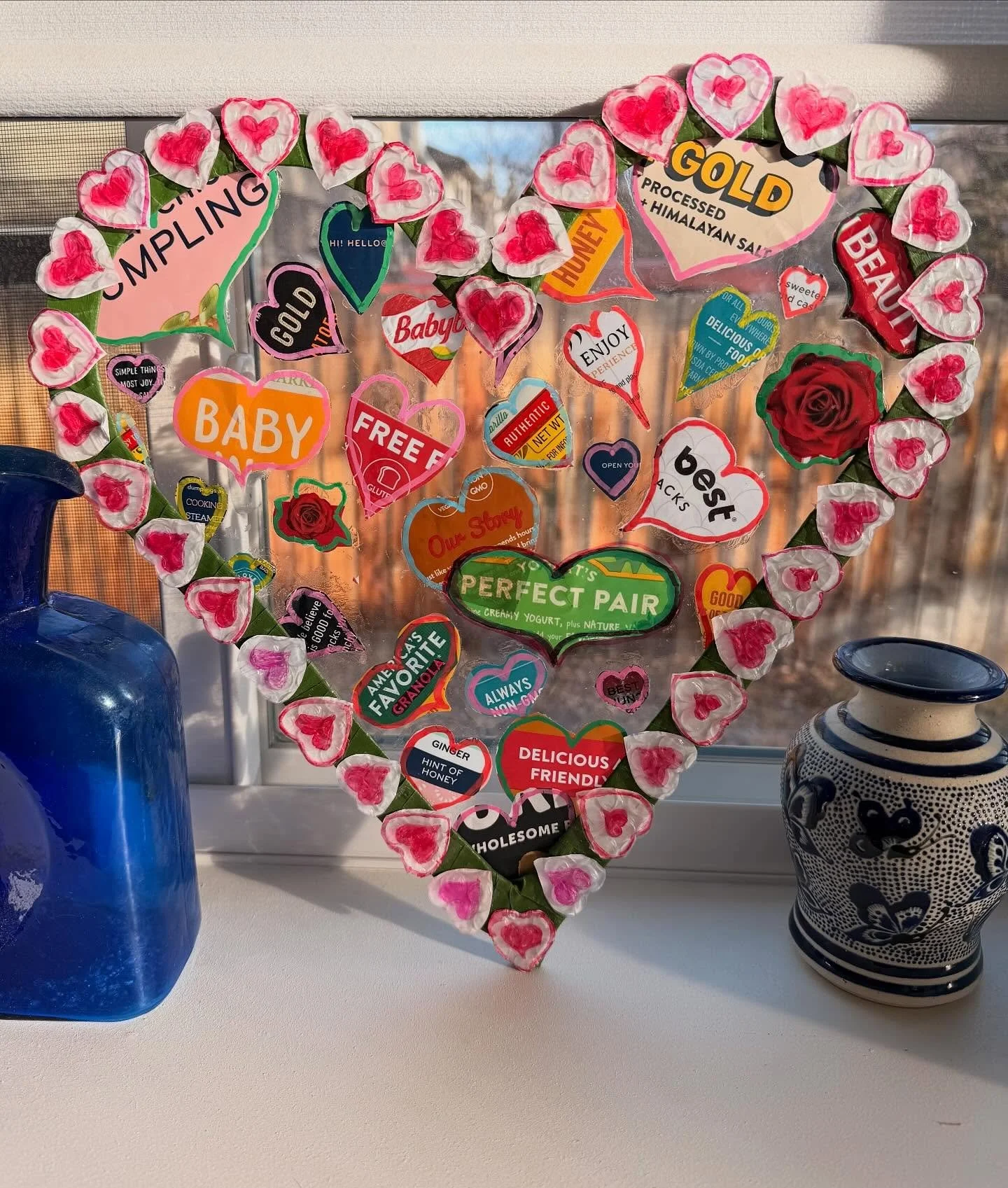 Valentine sun catcher made from plastic packaging. My favorite label was &ldquo;authentic&rdquo; because it&rsquo;s an important ingredient in love, but it got lost in the frame.