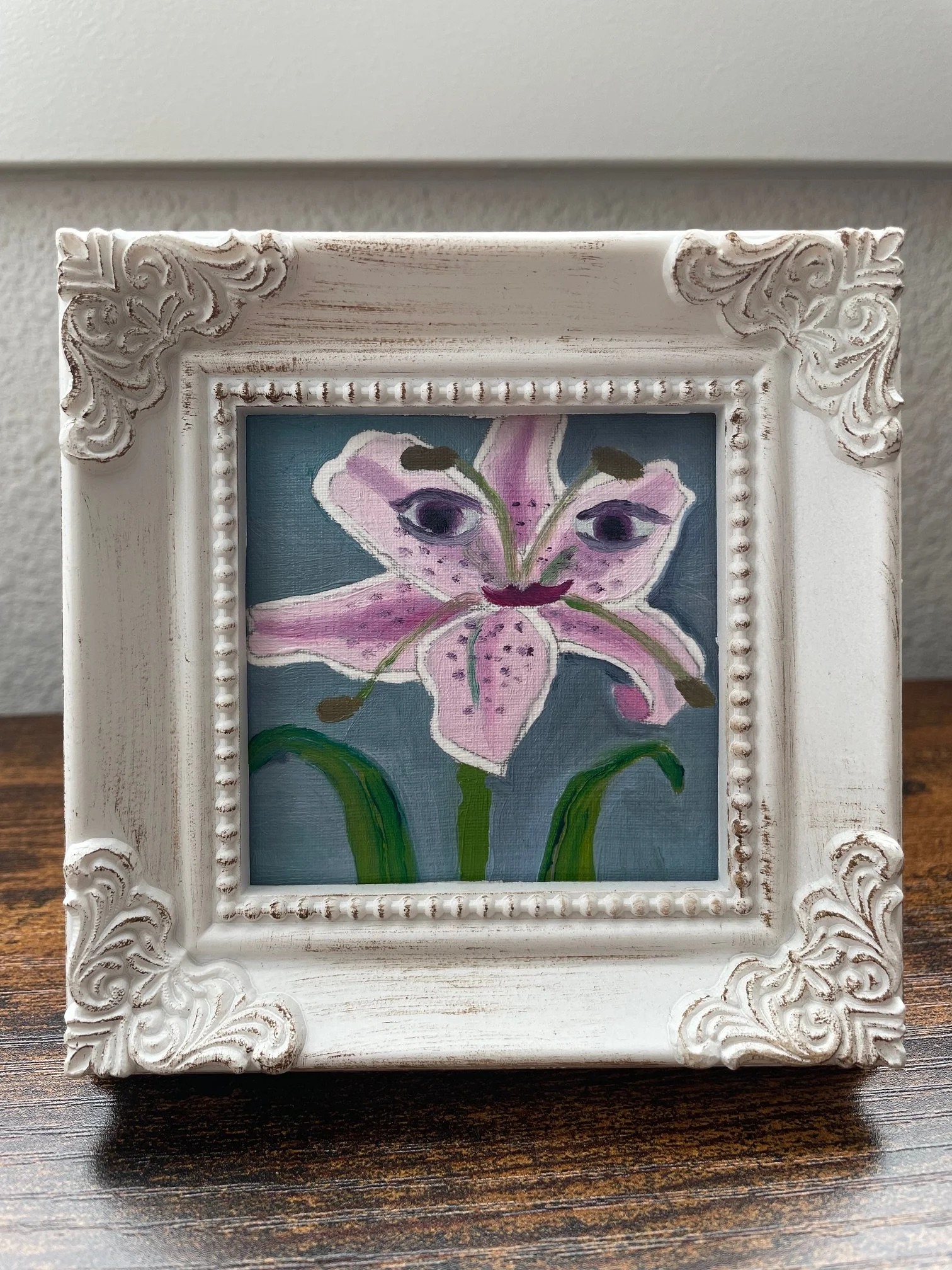 Oil painting of a stargazer lily with a face