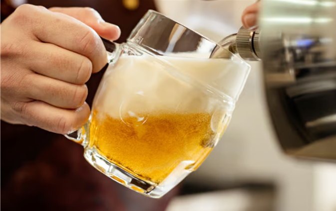 A beer being poured into a Tübinger mug at a Lokal pub.
