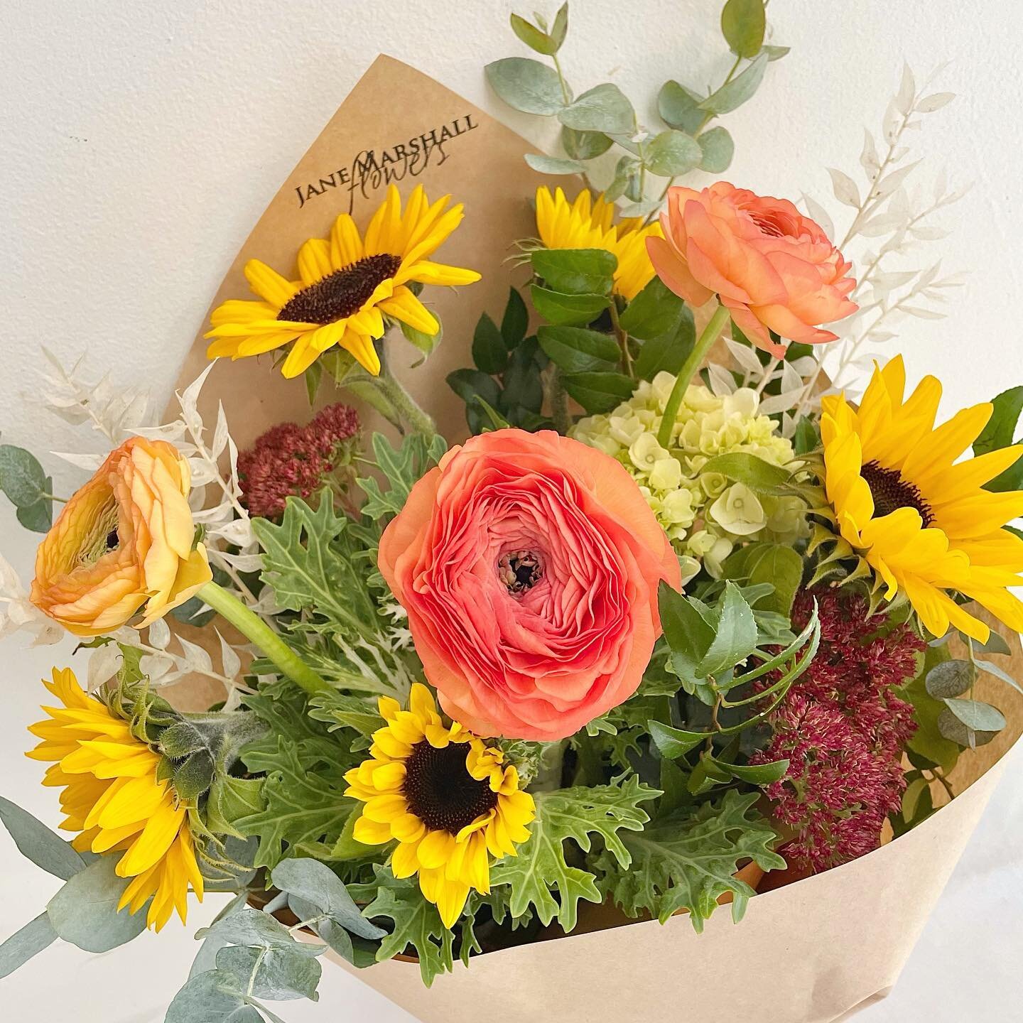 &bull;&bull; Weekly Special &bull;&bull;
Know someone who needs a boost this week? How about sending them (or yourself!) a little bunch of sunshine?! 
These are the last of the local sunflowers +  ranunculus, sedum, kale, hydrangea and eucalyptus. $4