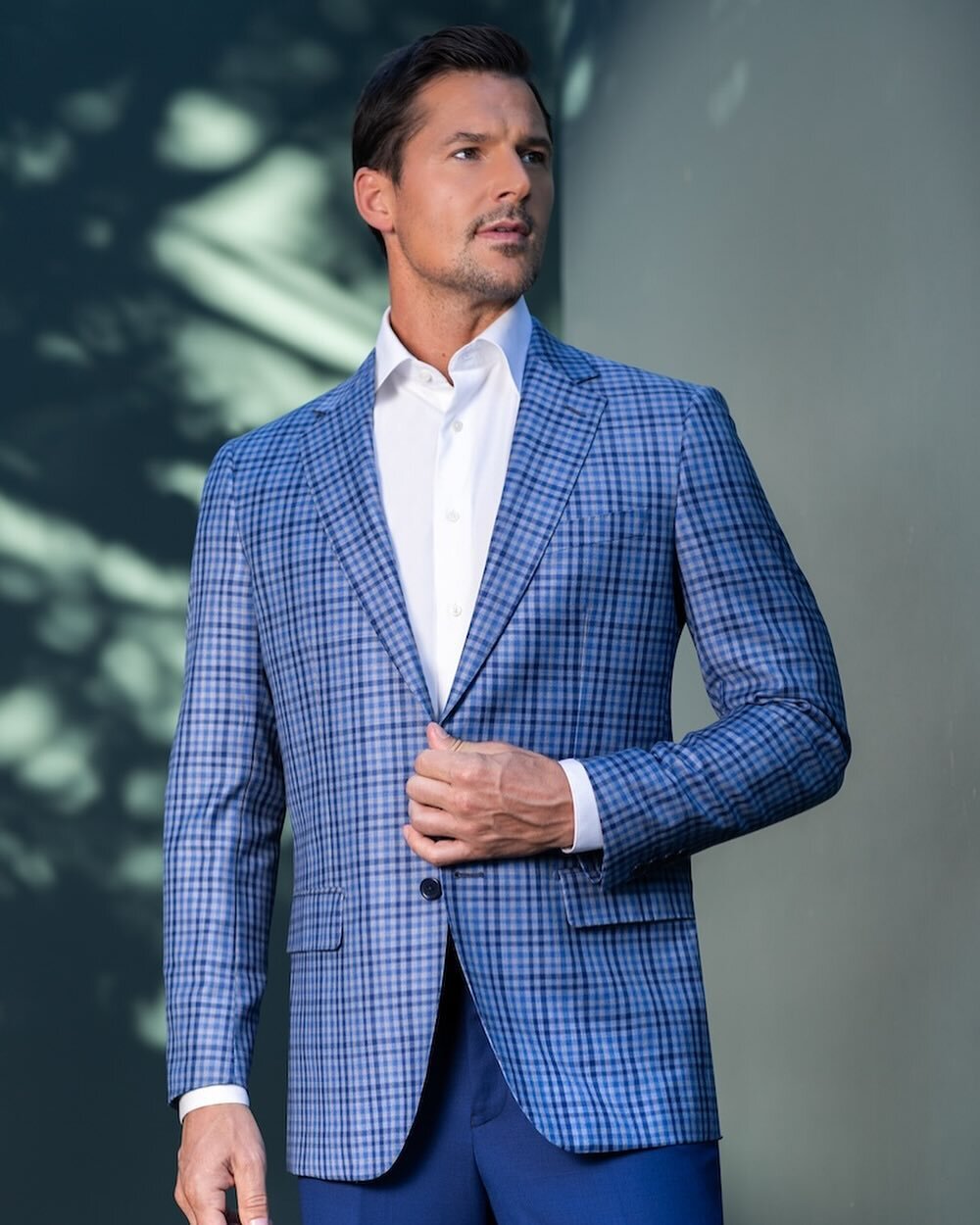 Introducing our latest showstopper - our Light Blue Check Tailored Coat. Impeccably crafted from the finest Italian fabric, this coat is the epitome of sophistication and style. The subtle yet striking check pattern is bound to turn heads wherever yo