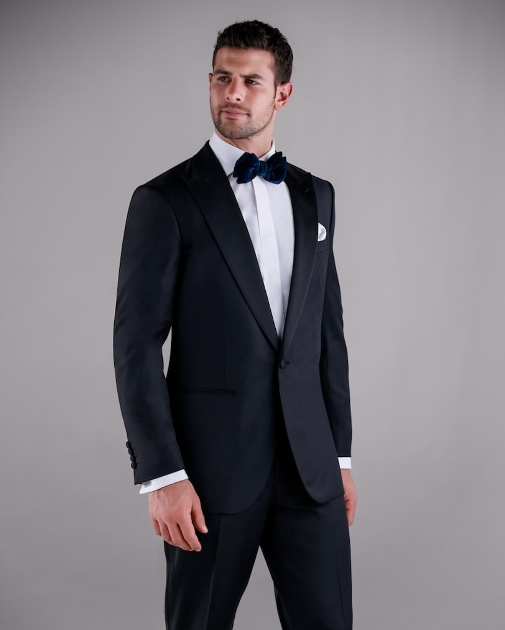 A classic, redefined. The 1-Button Peak Lapel Black Tuxedo is a timeless staple from our year-round Stock Program, designed for the modern gentleman who values sharp tailoring and enduring elegance. With its structured peak lapel and clean silhouette