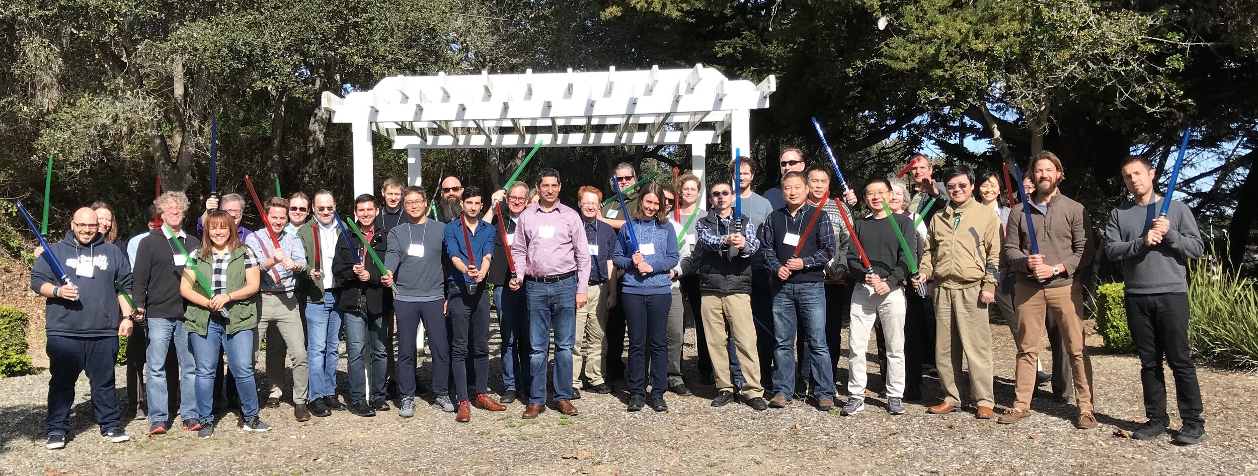 Graduates of the 4th JEDI Academy hold up their customary lightsabers in Monterey, California on February 28, 2020. It is typical for graduates of in-person JEDI academies to receive a lightsaber upon academy completion.