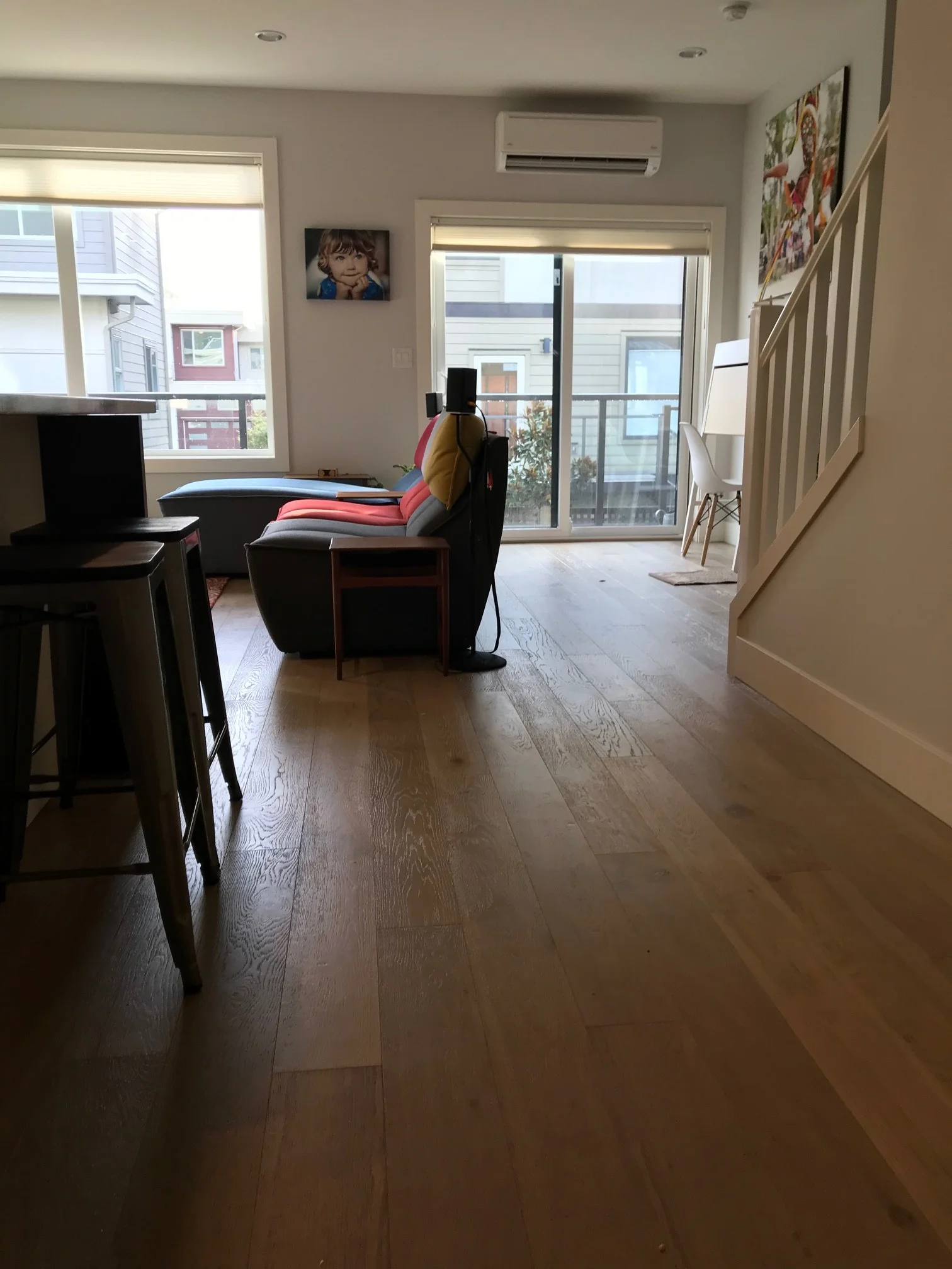 Long hallway in open concept living room / kitchen area.