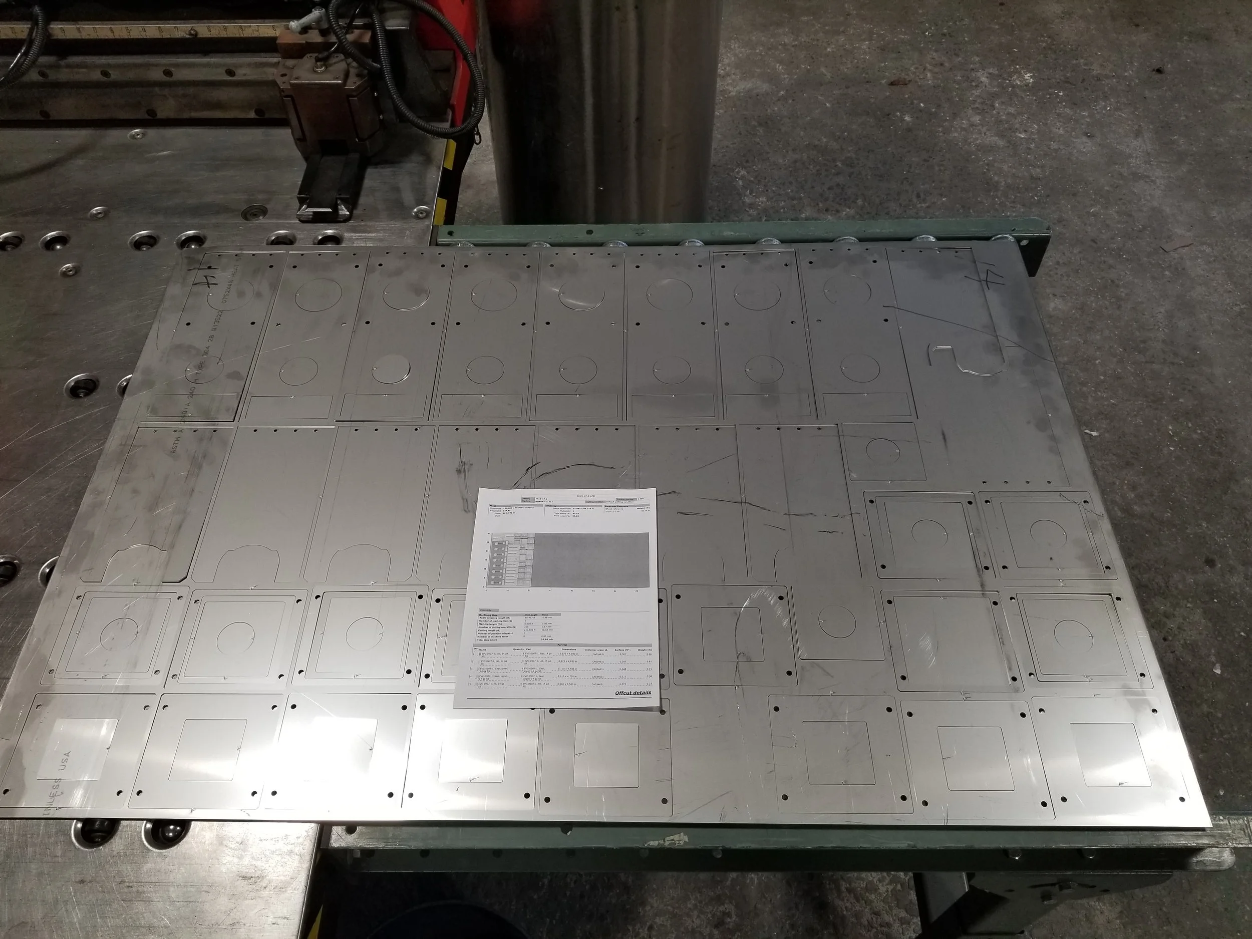 A batch of laser cut parts still in the nested state in the sheet.