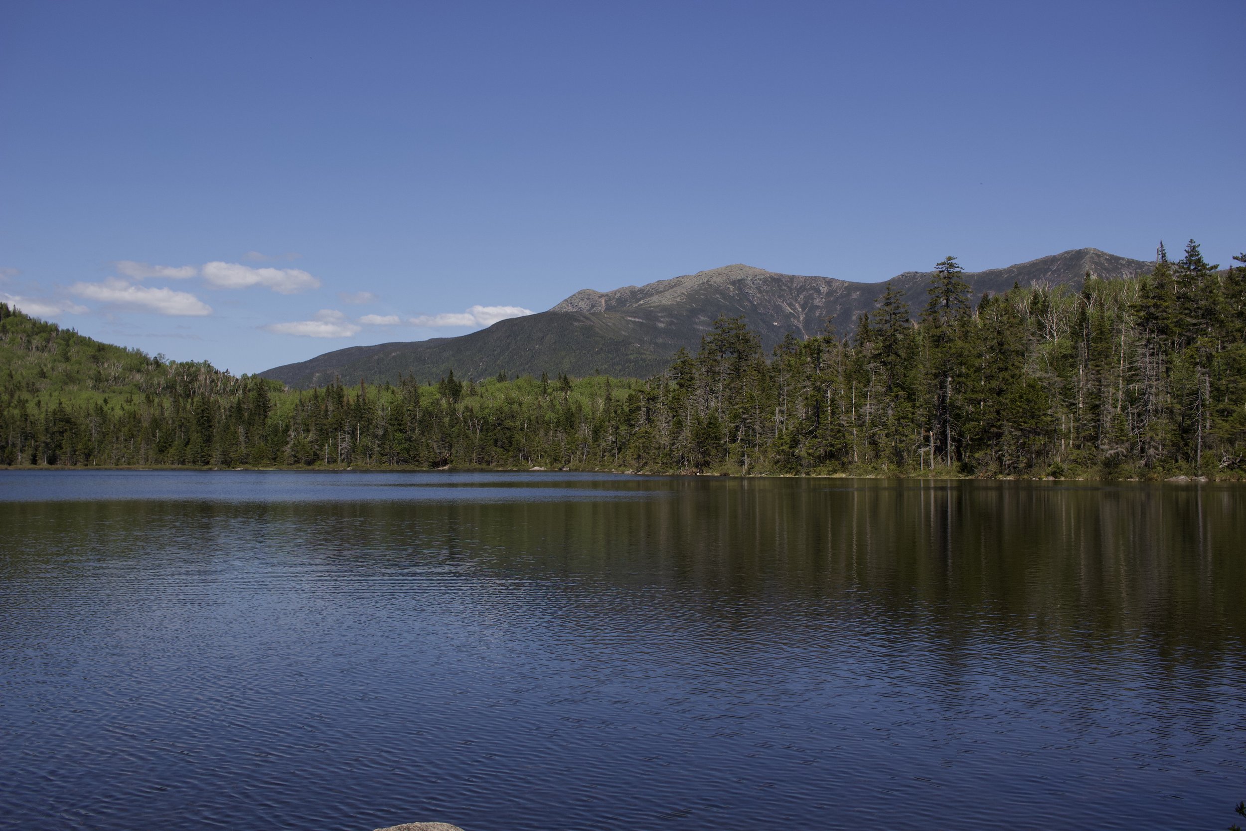 lonesome lake with views of mountains in distance