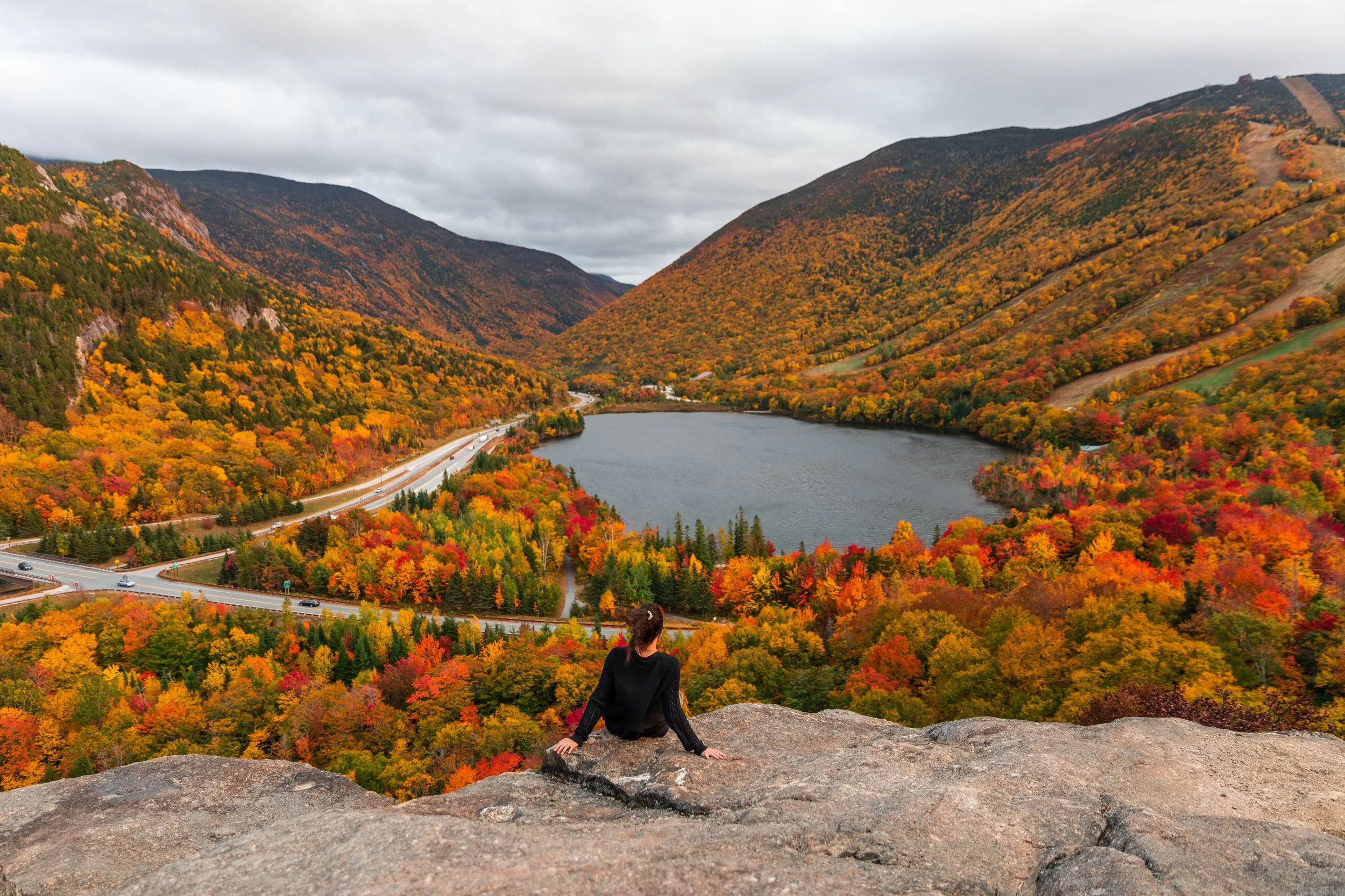 girl sitting on artist bluff during fall