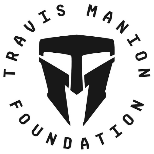 Logo of the Travis Manion Foundation with a stylized face mask graphic and the organization's name encircling it.
