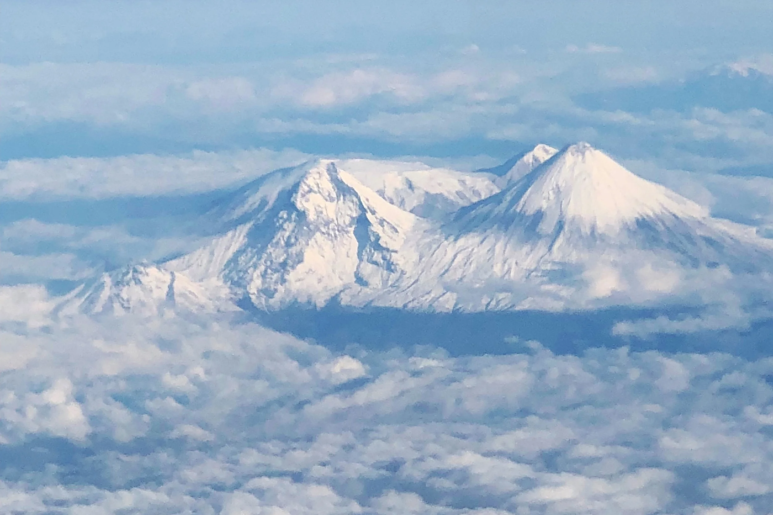 Kamchatka’s Volcanos viewed from the Charter flight from Anchorage to Petro. These beautiful volcanoes grace the skyline throughout our trip down the river.
