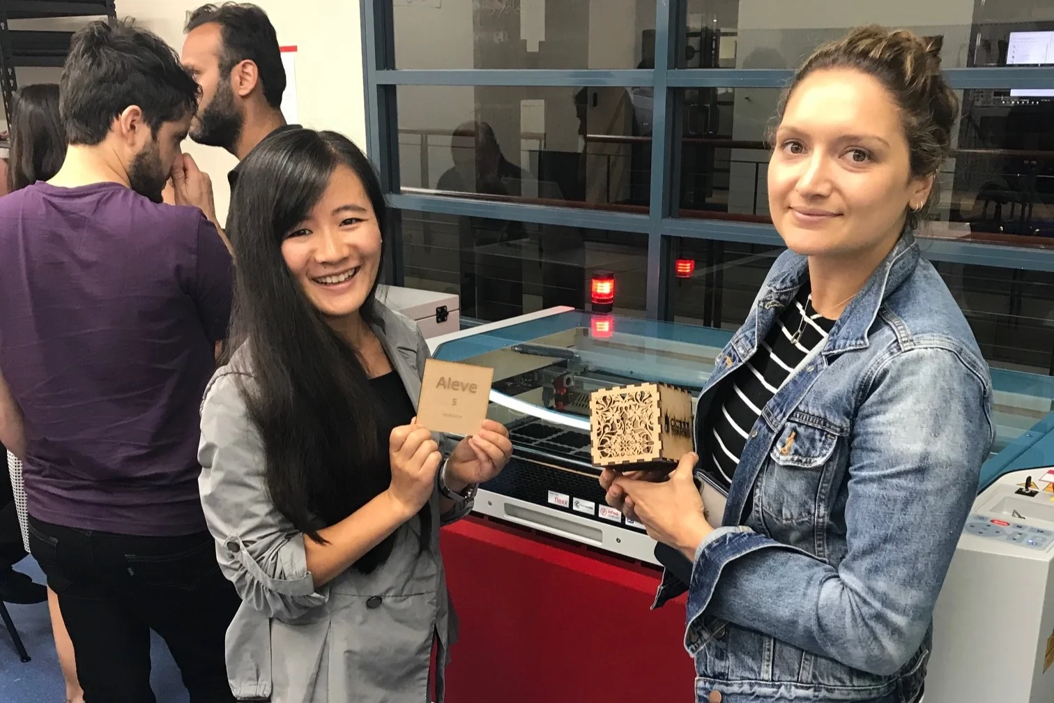 Girls showing laser cutting materials