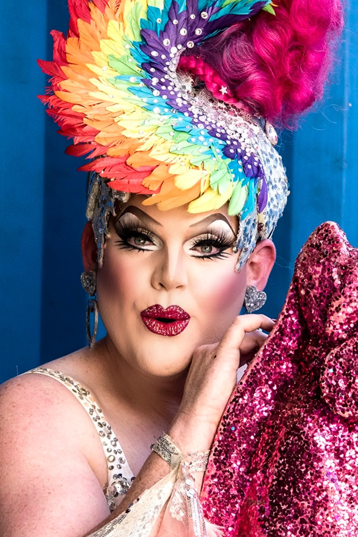 Sydney Drag Queen Carmen Geddit wearing a rainbow feathered headdress. Mardi Gras 2022. RuPaul's Drag Race Down Under.