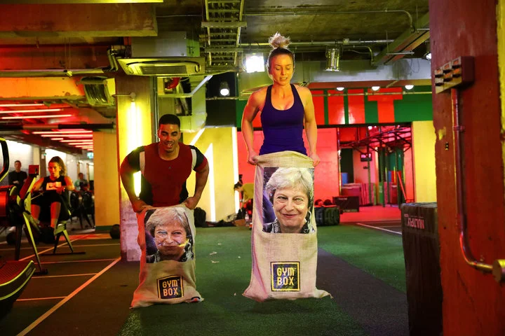 SIMON DAWSON / REUTERS Gym members jump in sacks containing an image of Britain’s Prime Minister Theresa May during a Brexfit gym class.