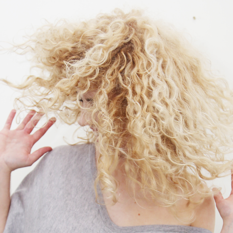 woman with frizzy curly hair.png
