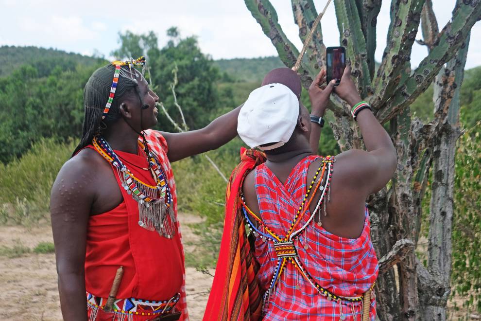 Two Maasai warriors photograph an Olpopongi tree ( Euphorbia Candelabrum) © Megan Laws