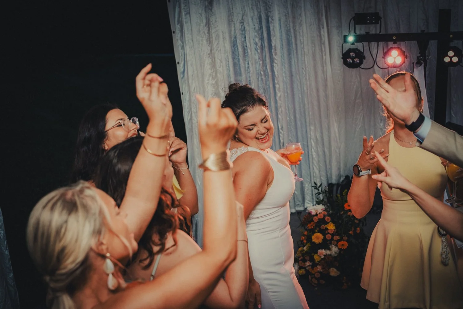 Bride dancing with friends during wedding party