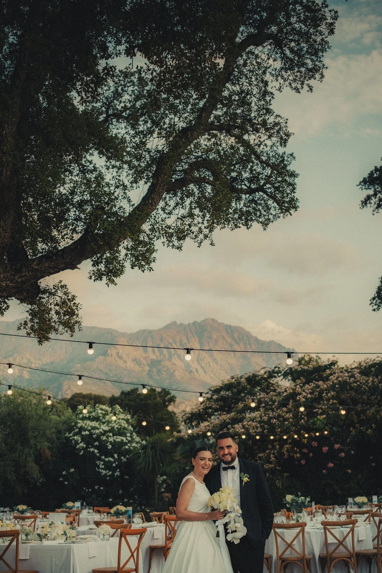 Outdoor wedding dinner under string lights in Corsica