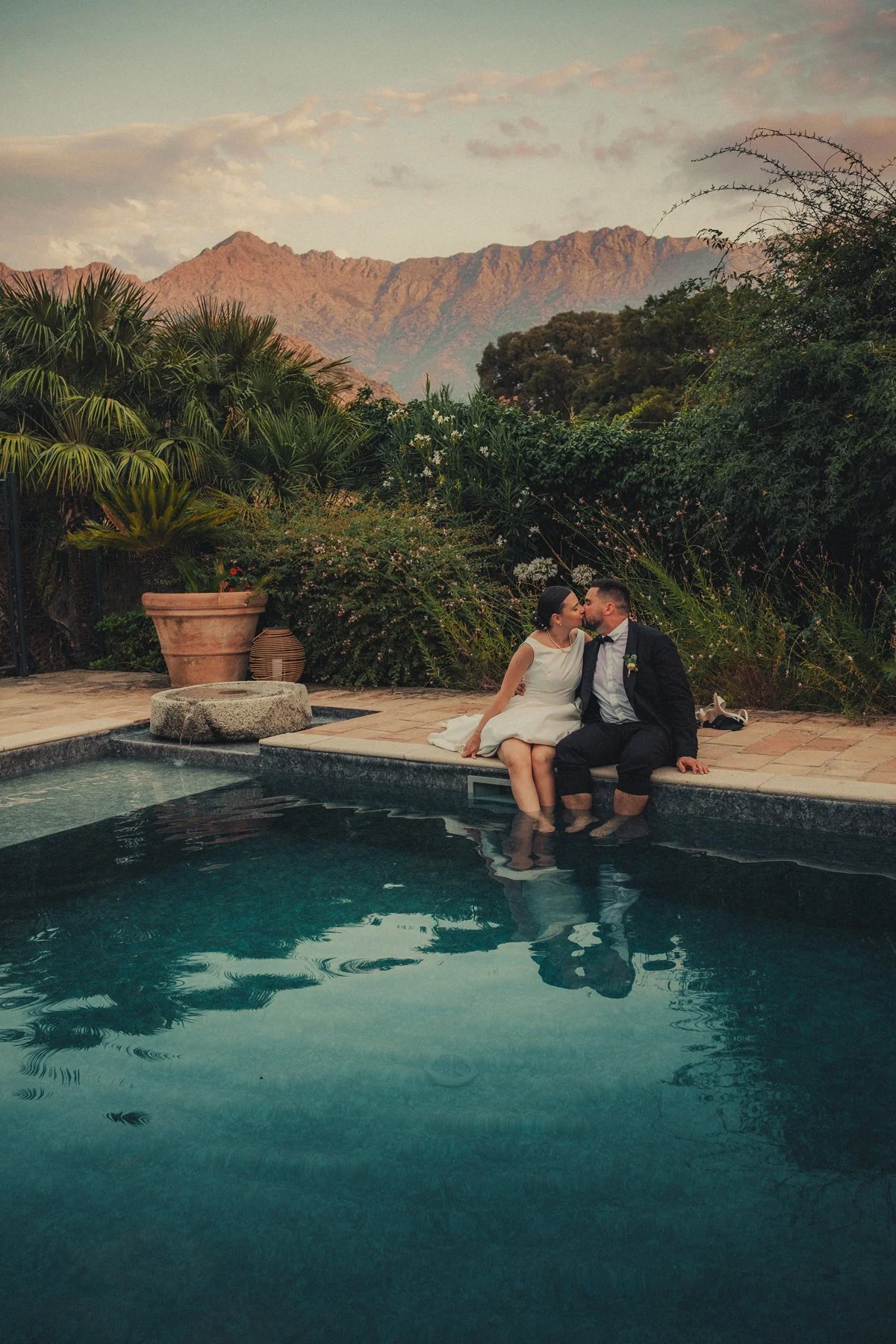 Corsica wedding photographer capturing bride and groom taking a moment together by the pool in Corsica