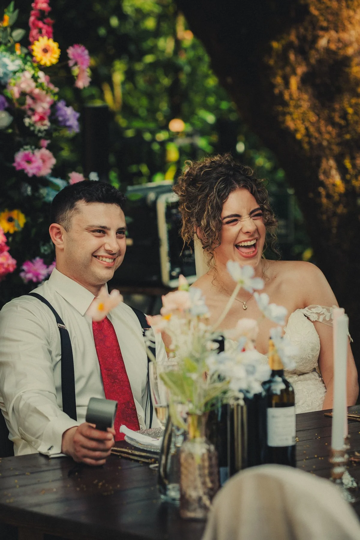 Bride and groom laughing at the dinner during speech moments at Chateau du Raysse located in Dordogne France.