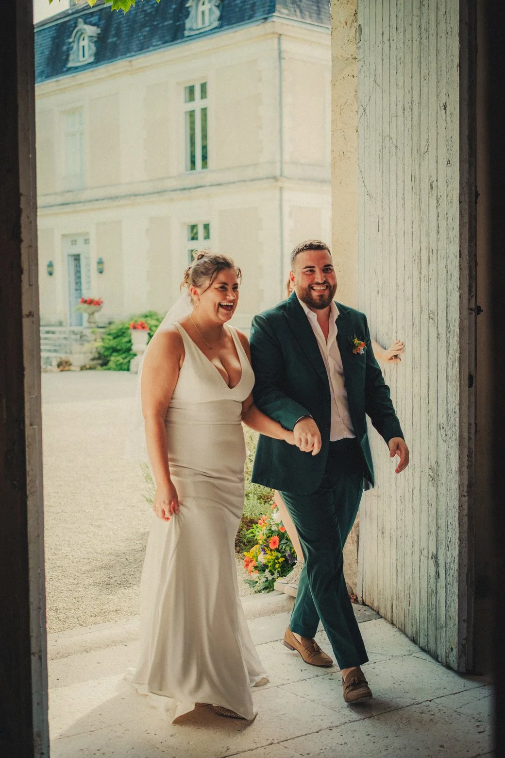 Bride and groom entering dinner reception at château wedding
