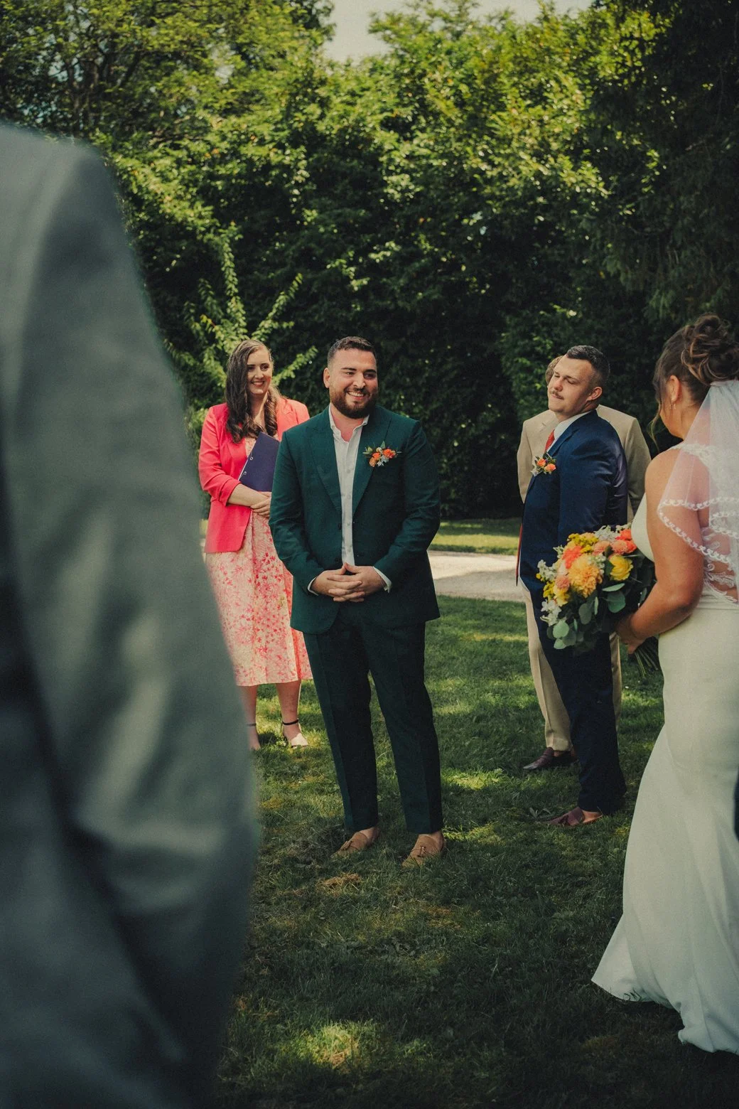 Emotional groom reacting as bride walks down the aisle