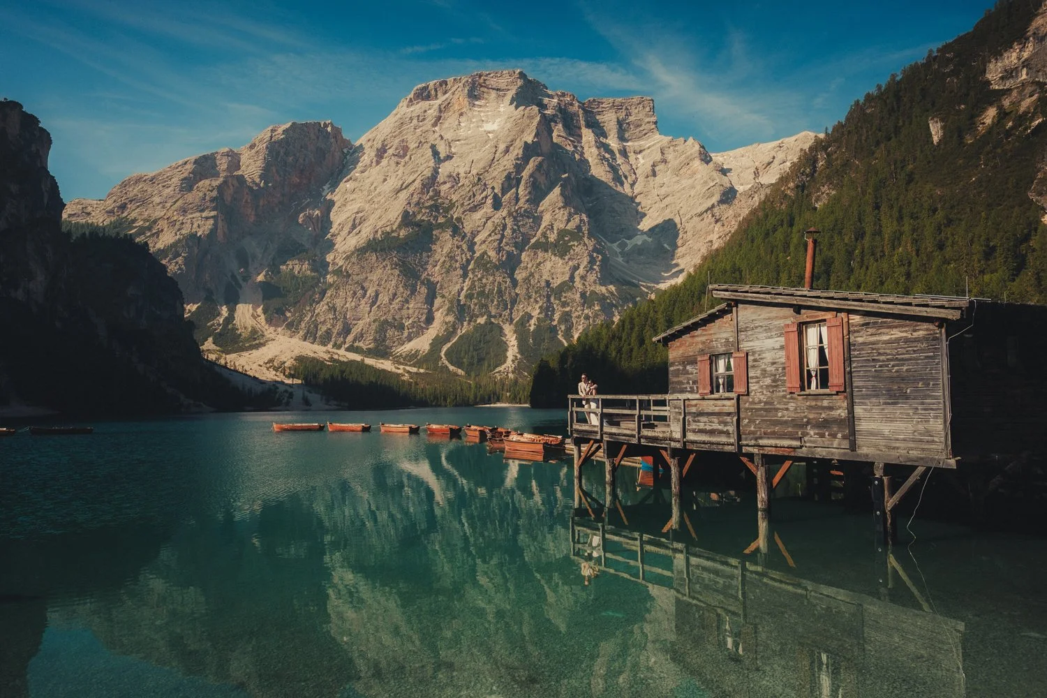 Lago di Braies elopement photographer capturing a couple in the boathouse
