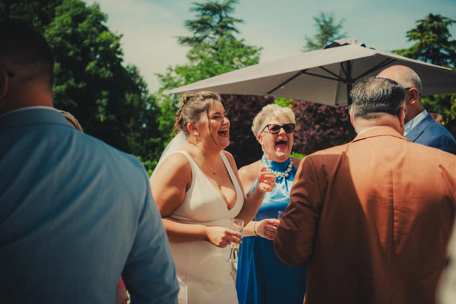 Wedding guests laughing during cocktail hour in Dordogne