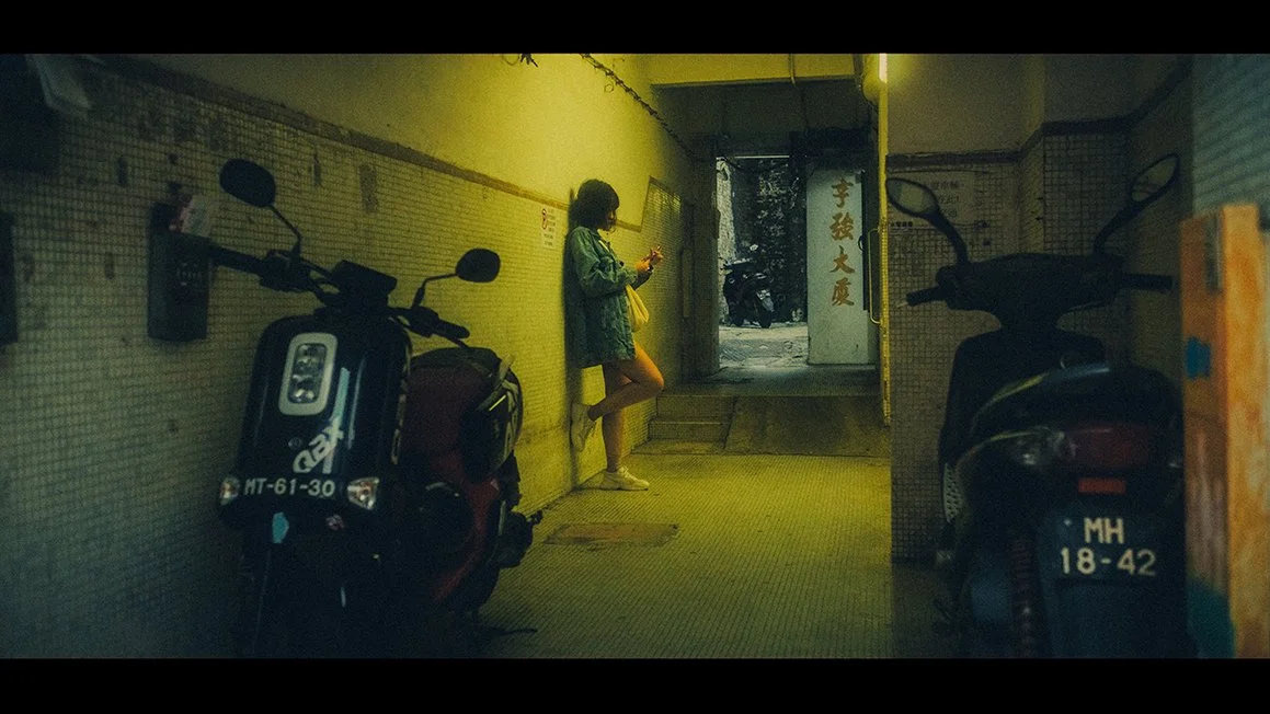 Cinematic Wong Kar Wai style Hong Kong elopement photography featuring neon street reflections at night.