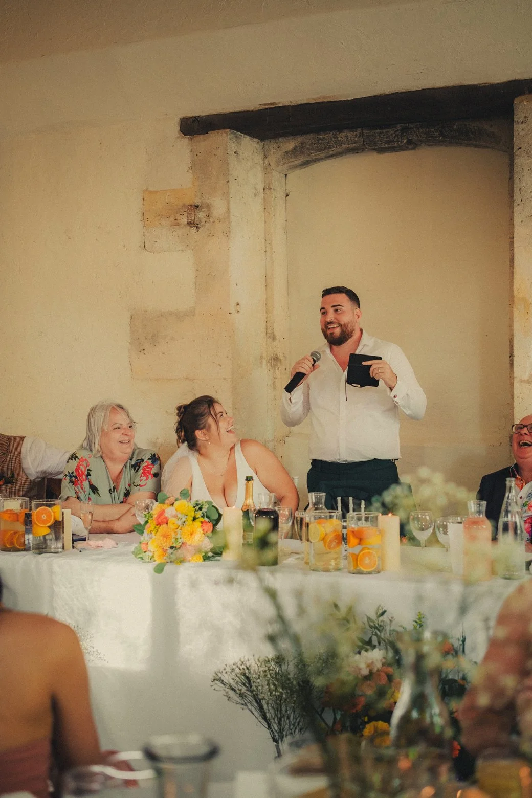 Groom giving emotional speech during wedding dinner