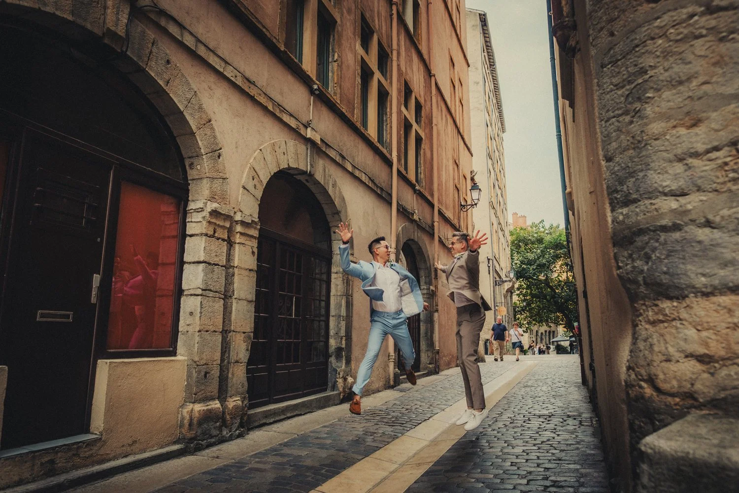 Deux mariés sautant de joie pendant leur séance photo dans le Vieux Lyon