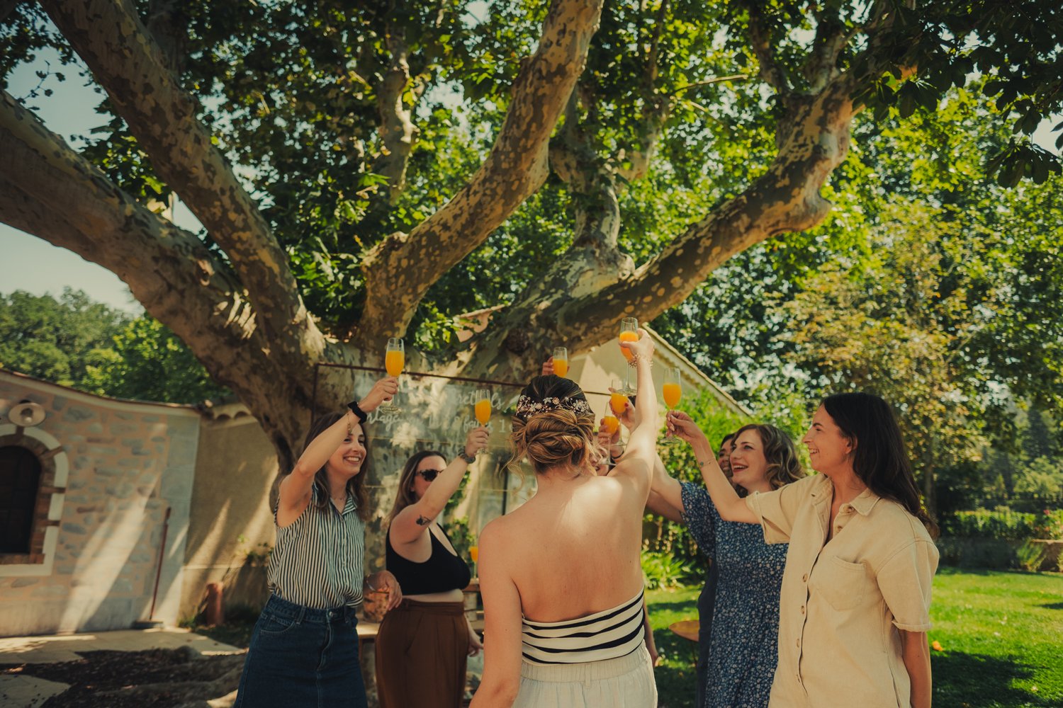 The bride and her bridesmaids cheering together before the wedding ceremony in Provence.