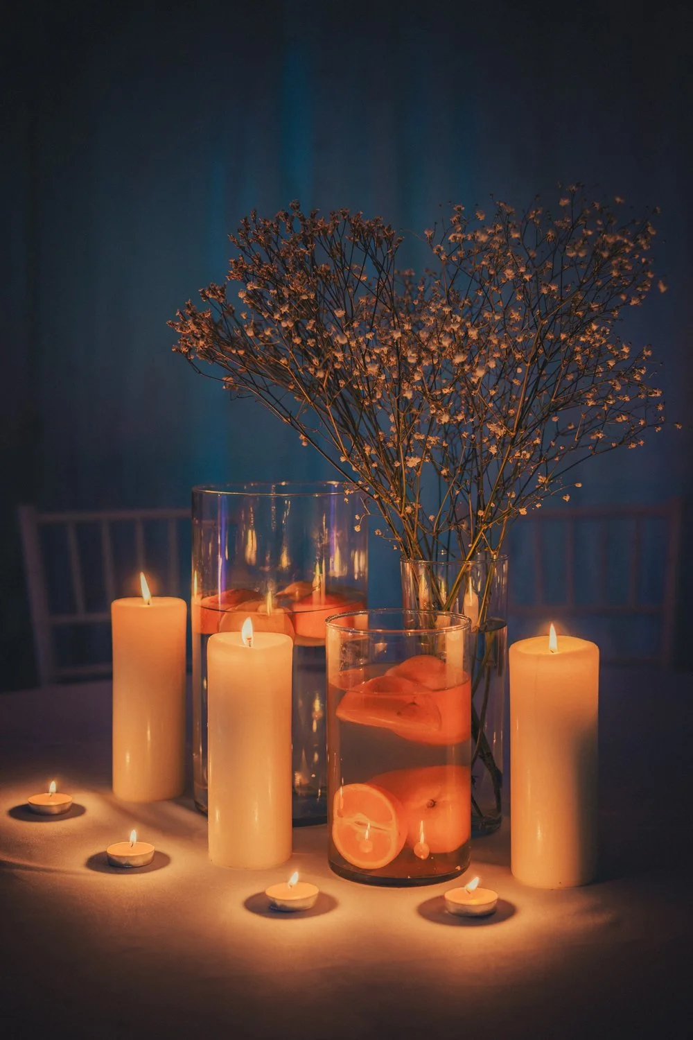 Wedding table decoration with candles and oranges