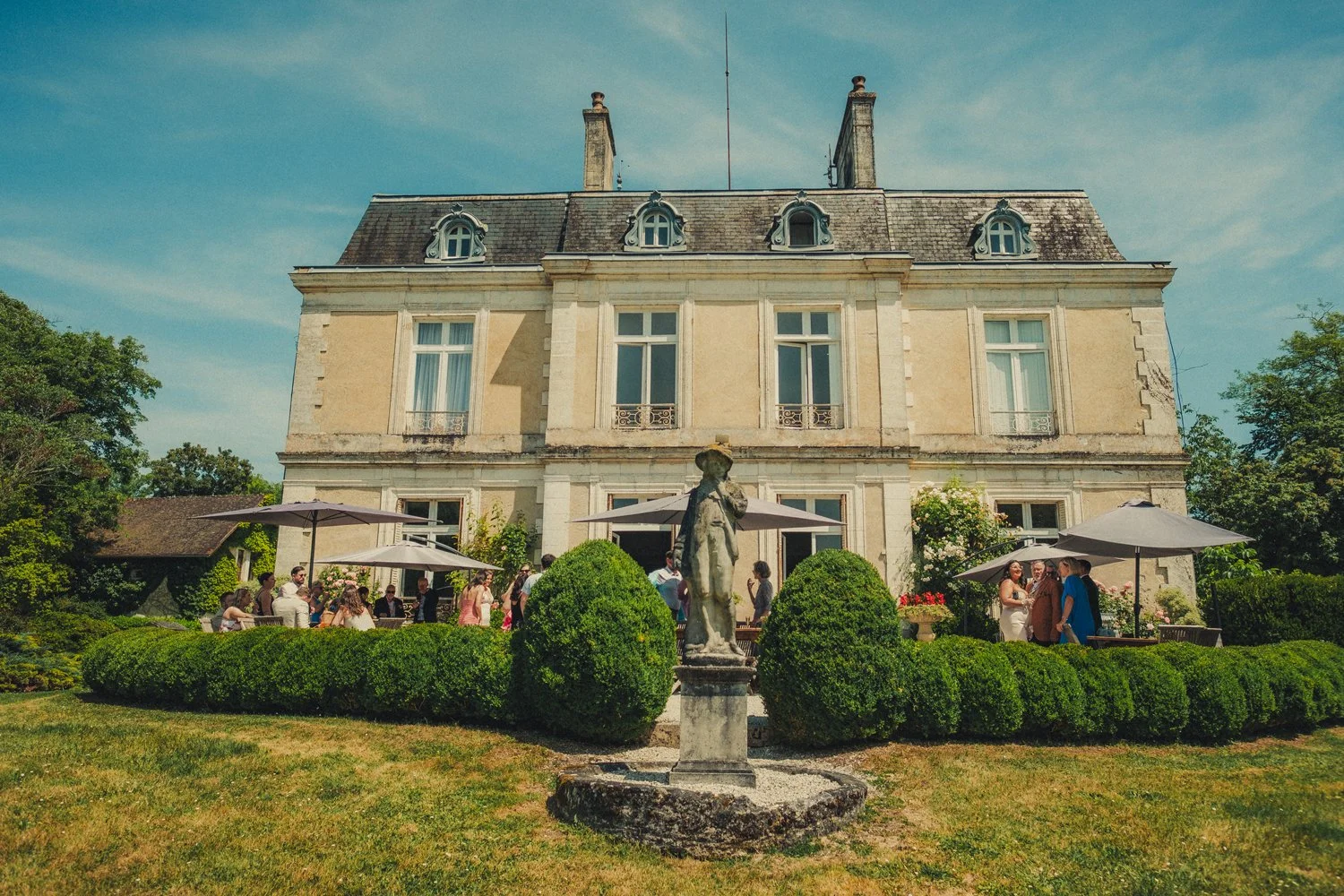 Guests enjoying cocktail hour on balcony of Château La Gauterie