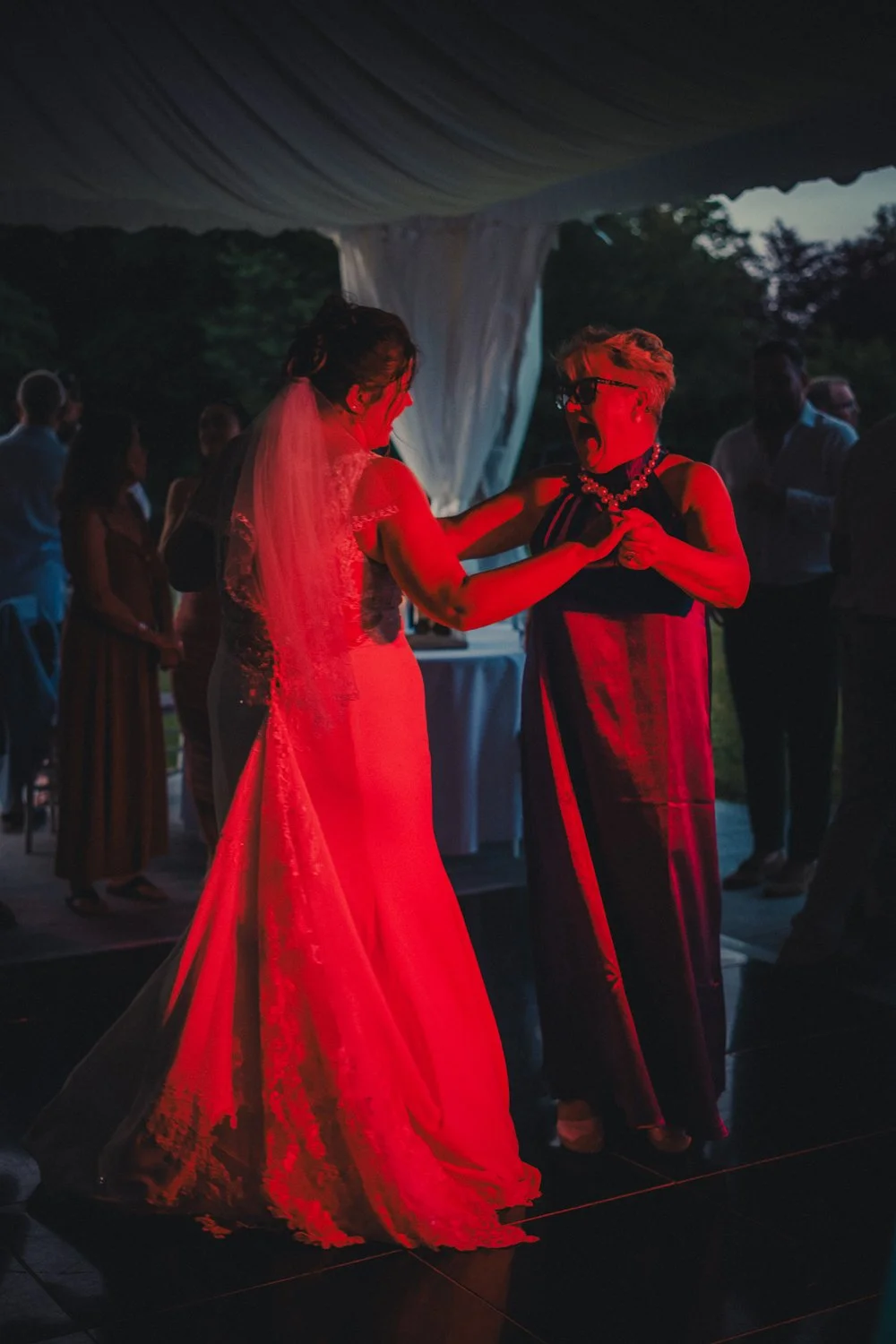 Bride dancing joyfully with her mother