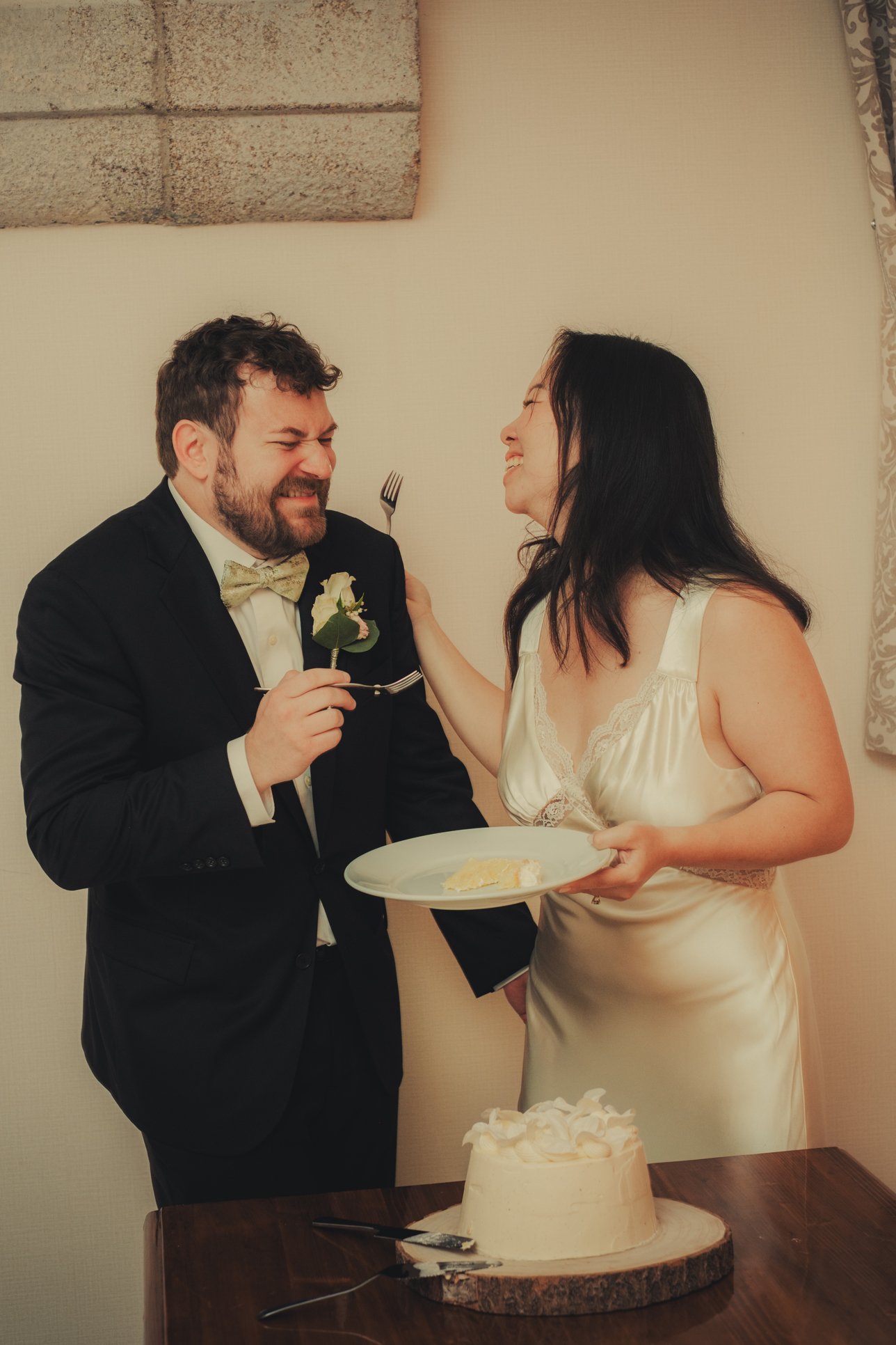 Bride and groom enjoying wedding cake at the Chateau du Doux.