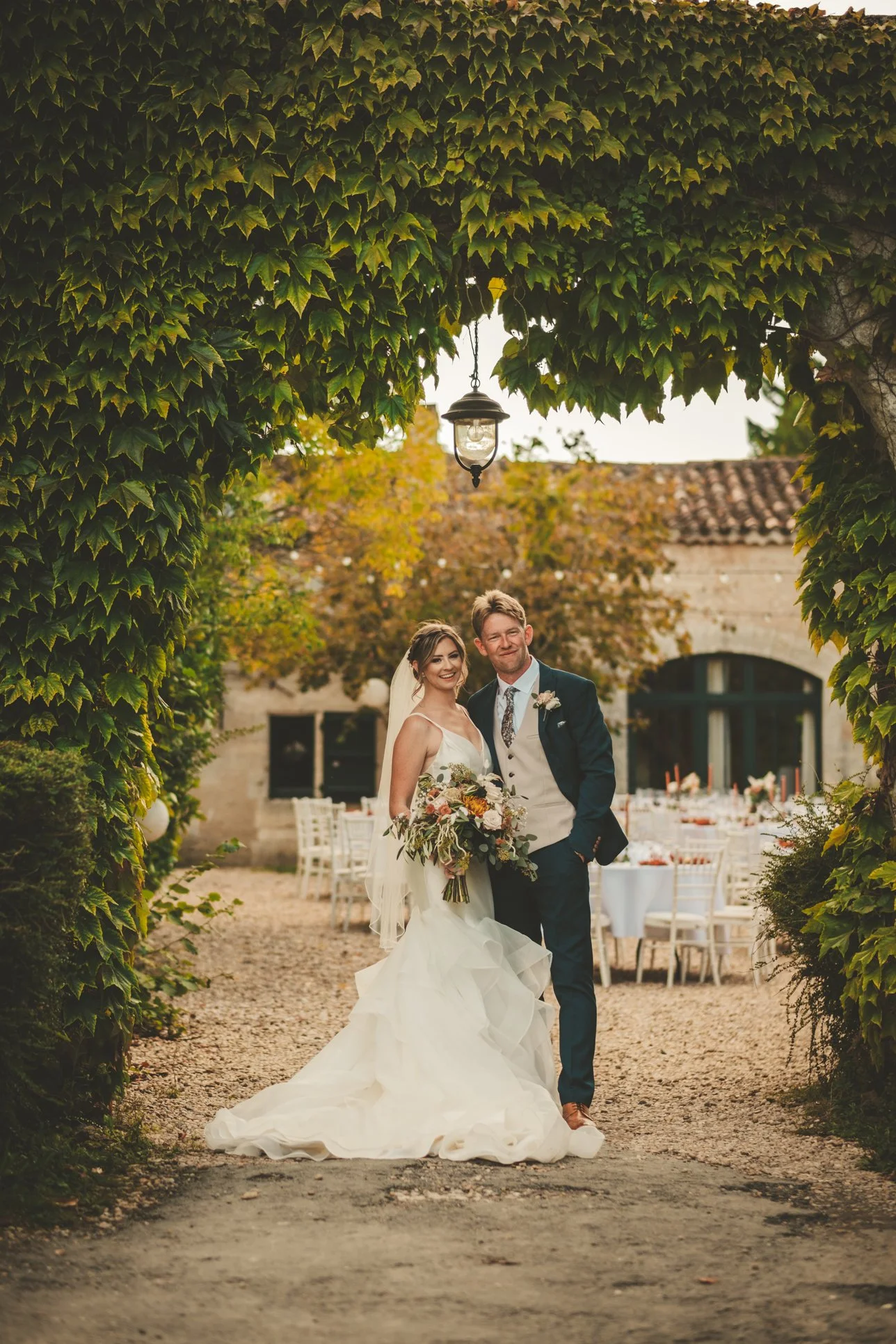 couple pose in front of the wedding dinner area