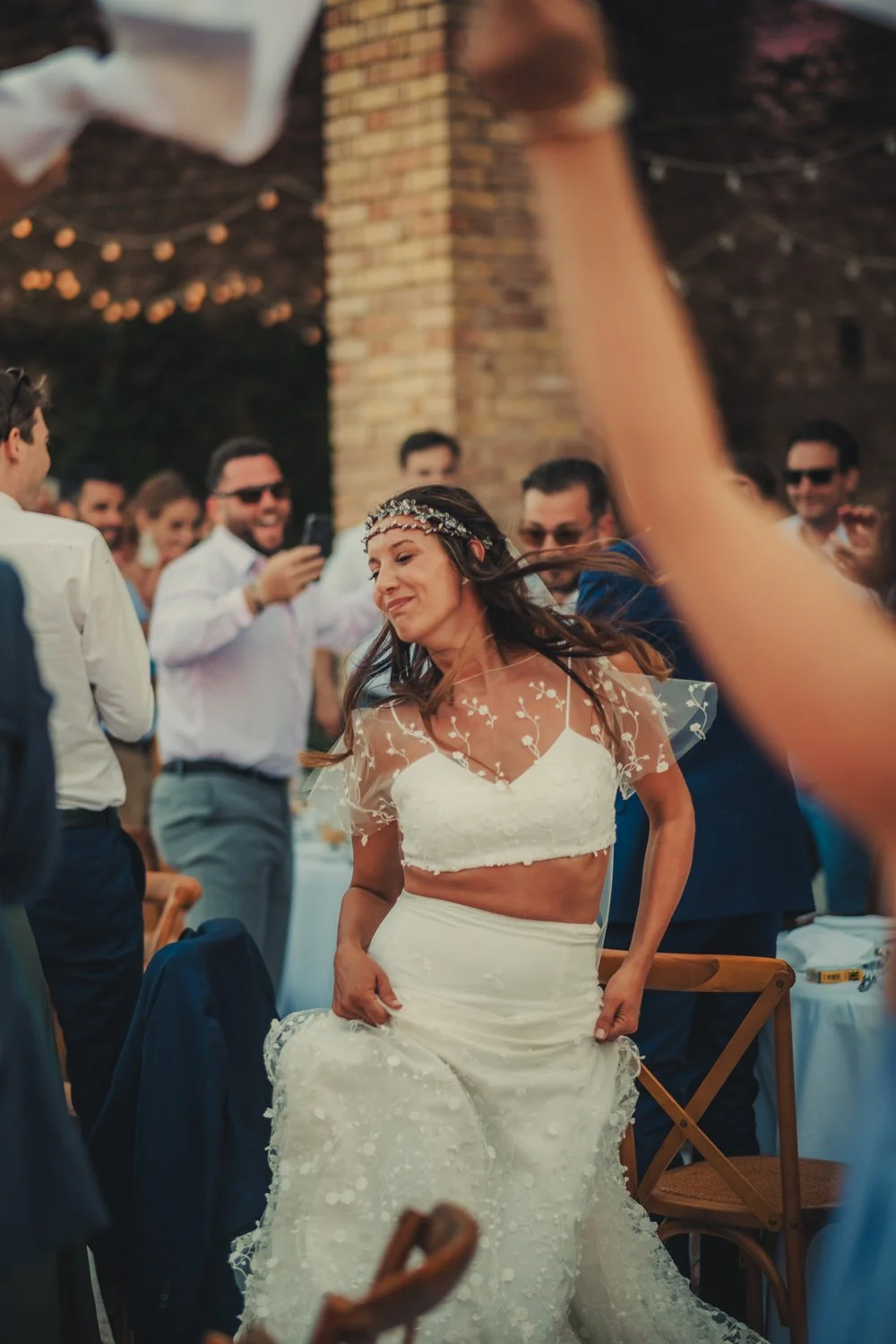 Bride entering the outdoor wedding dinner area in Provence with a music.