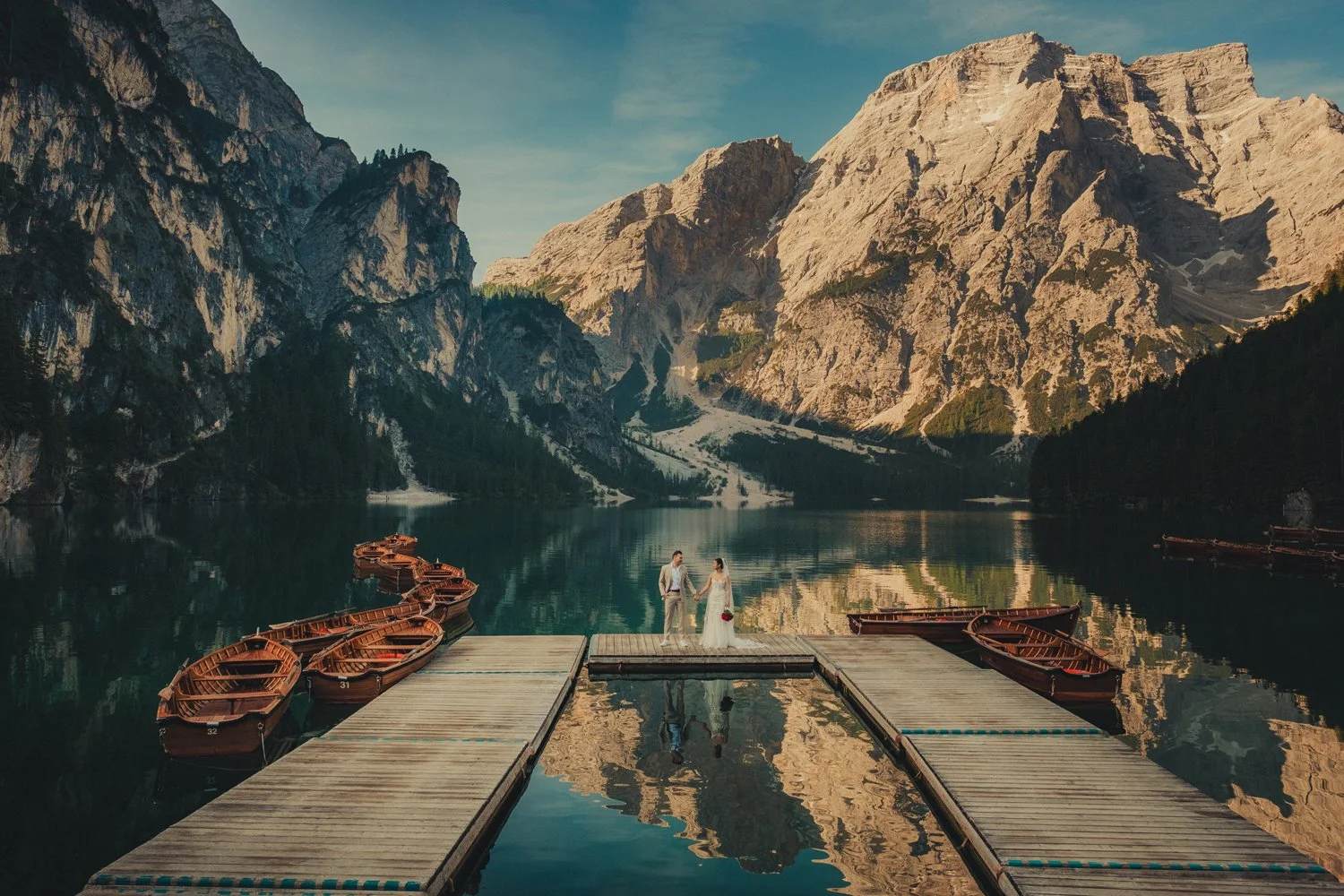 Lago di Braies elopement photographer capturing couple in June at the boathouse