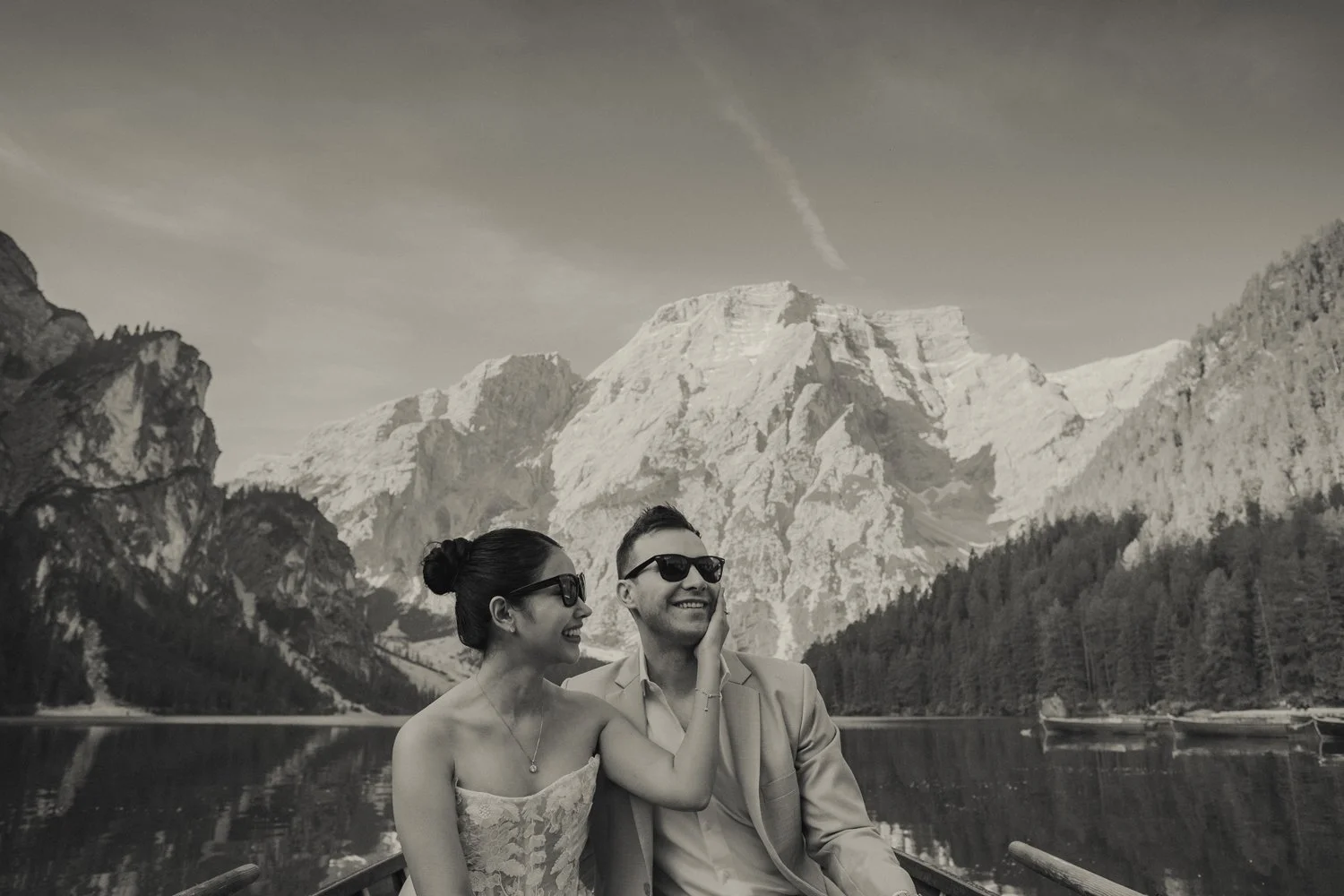 Lago di Braies elopement photographer capturing couple in boat in black and white